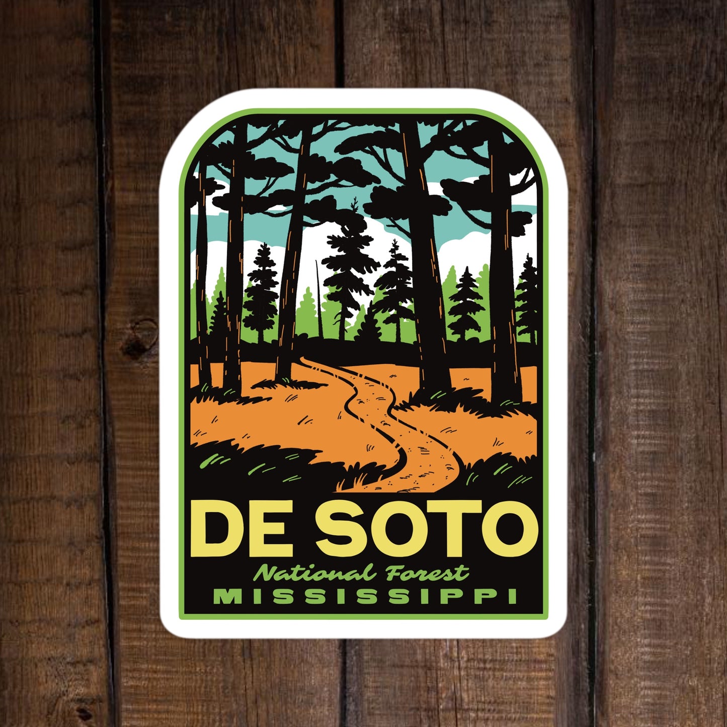 Sticker of De Soto National Forest, Mississippi with a forest design on a wooden background.