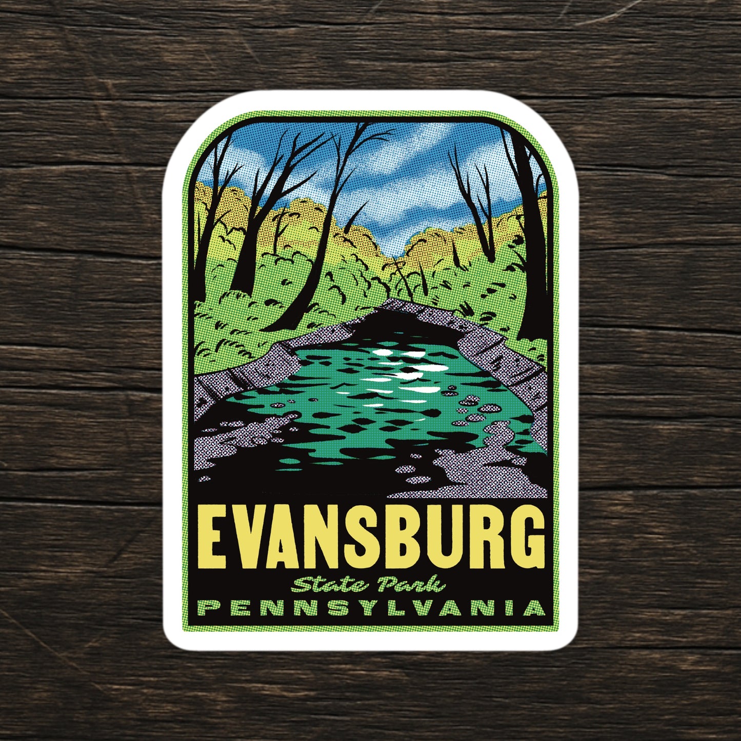 Sticker of Evansburg State Park, Pennsylvania with a scenic design on a wooden surface.
