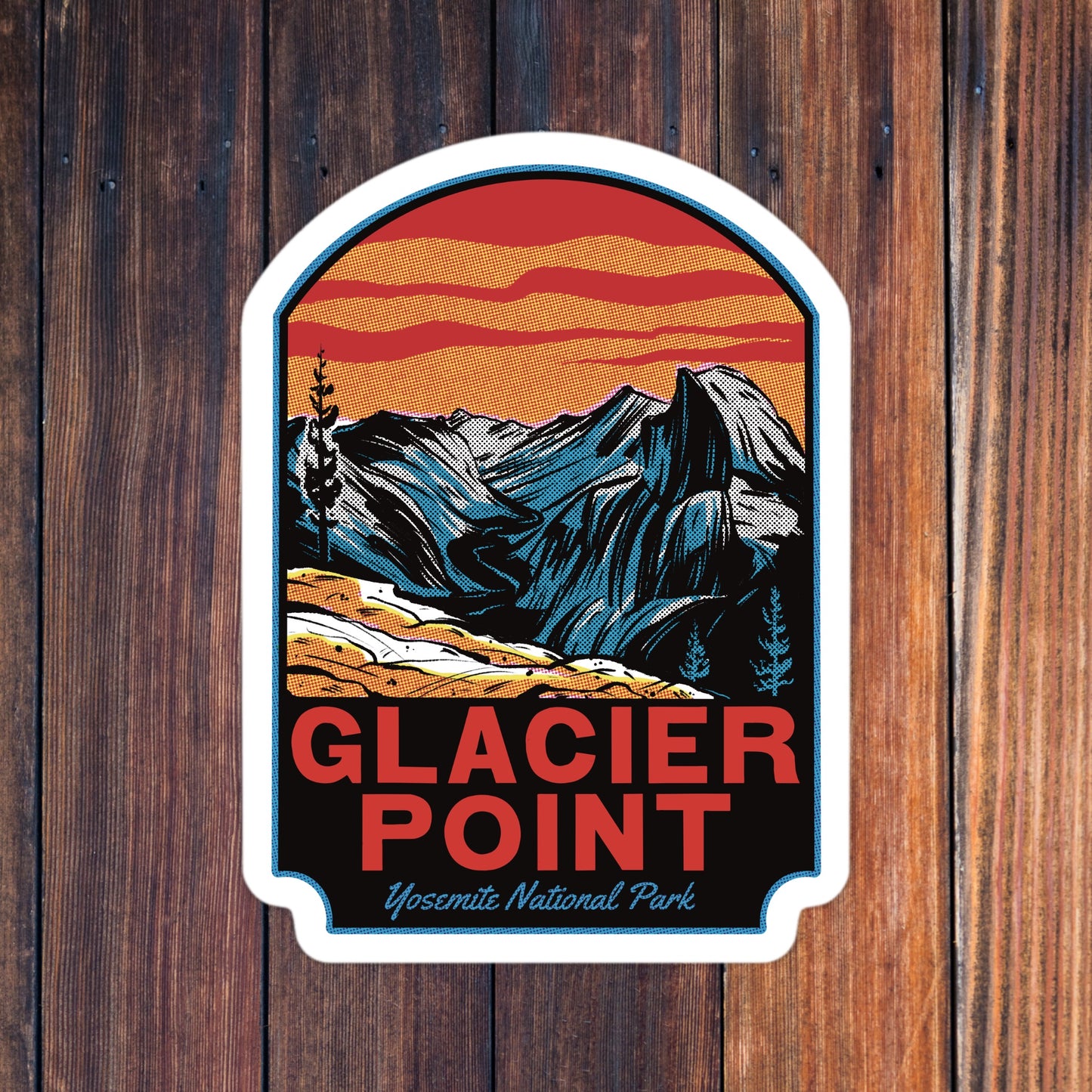 Sticker with mountain design and 'Glacier Point' text on a wooden background