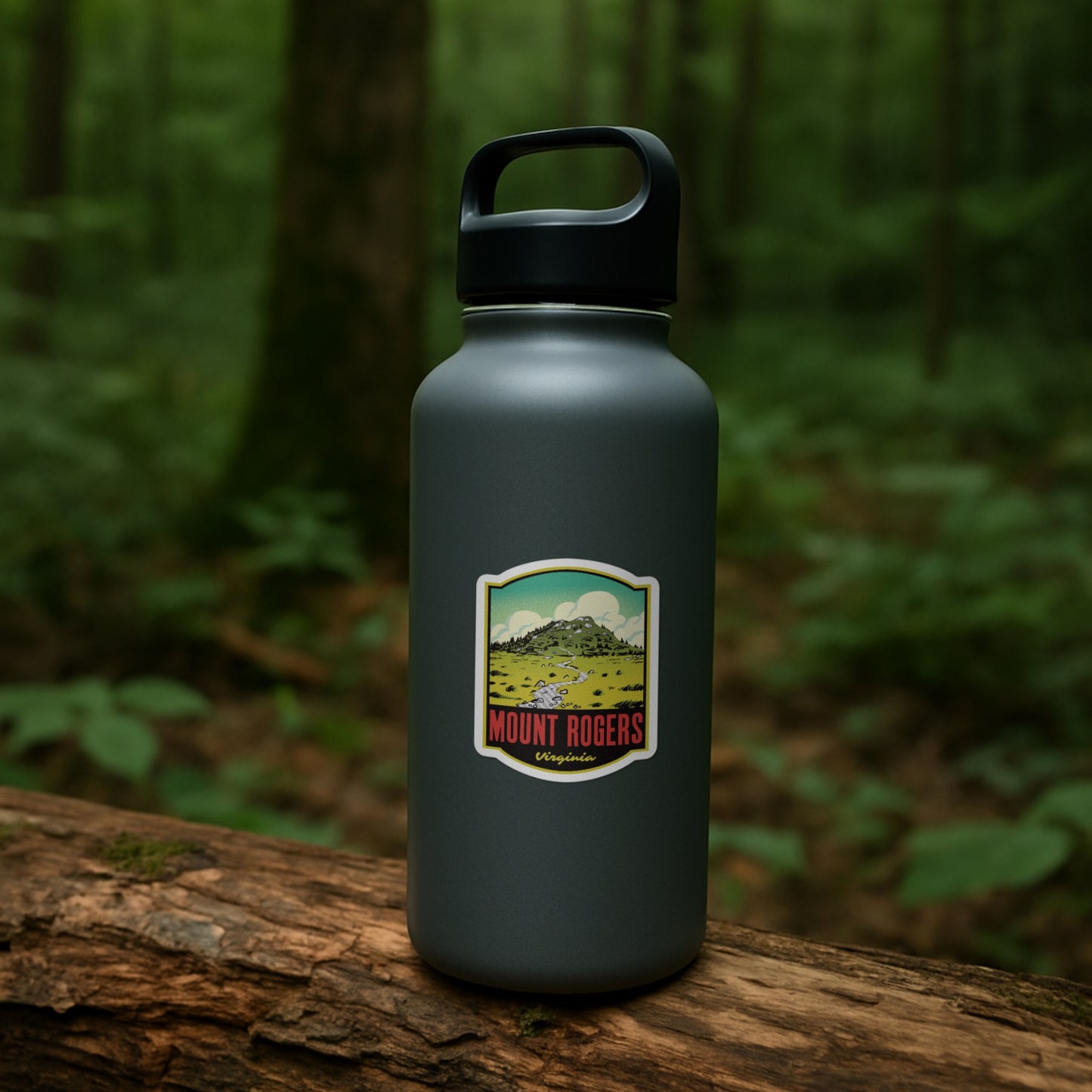 Black water bottle with Mount Rogers sticker on a wooden log in a forest setting
