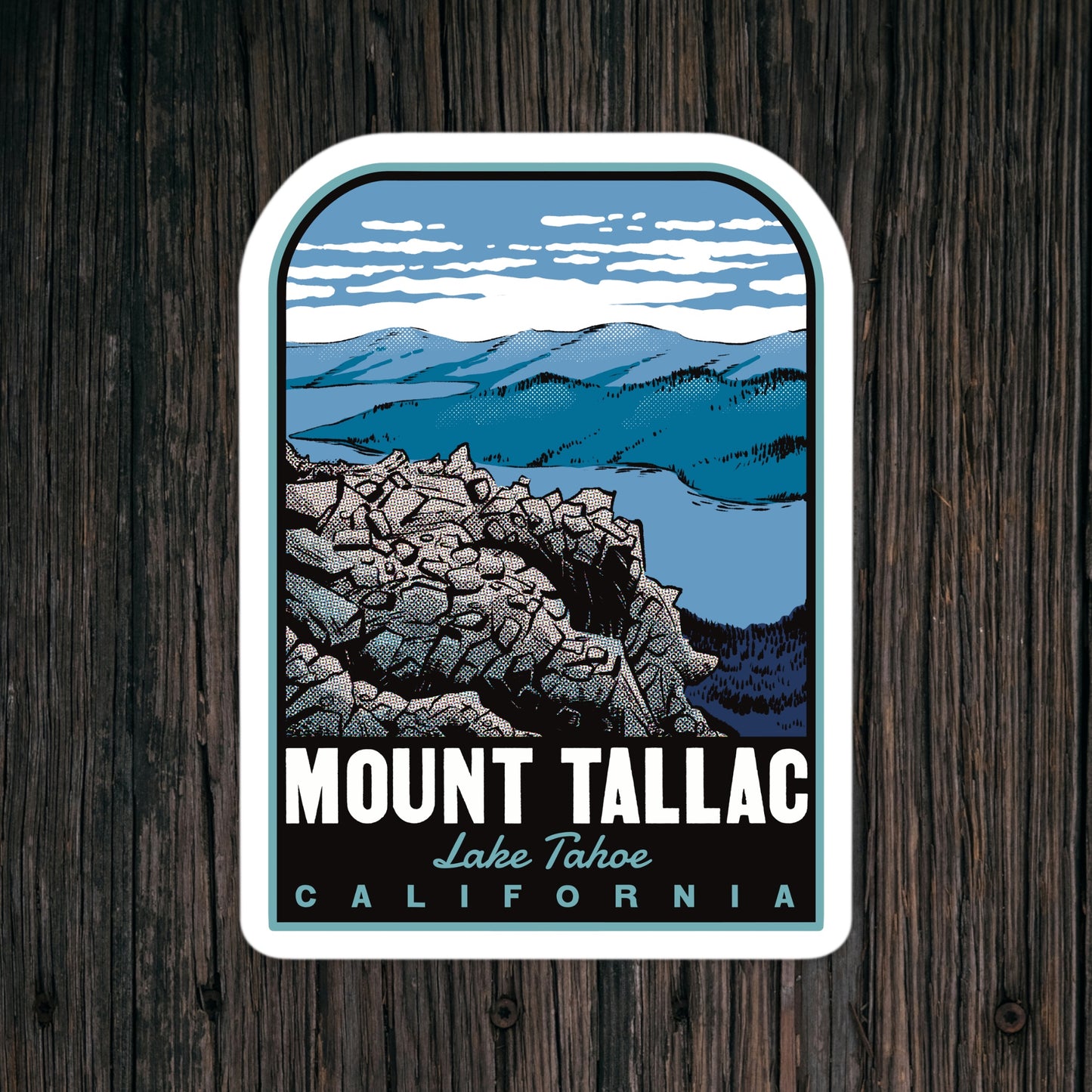 Sticker with Mount Tallac design on a wooden surface