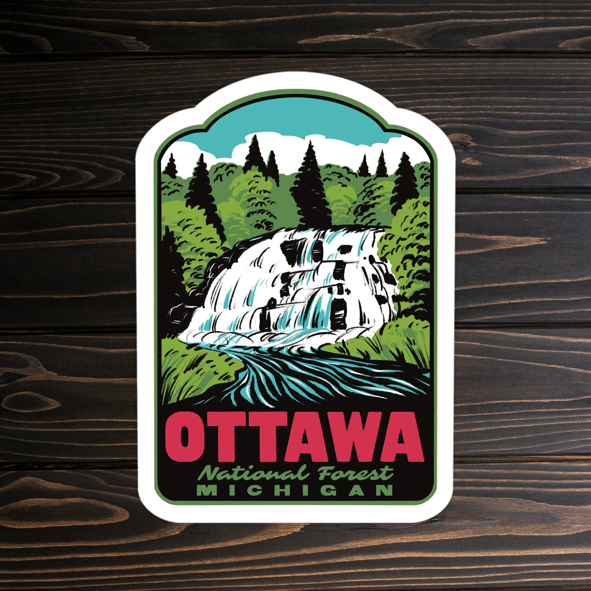 A sticker of Ottawa National Forest on a wooden surface