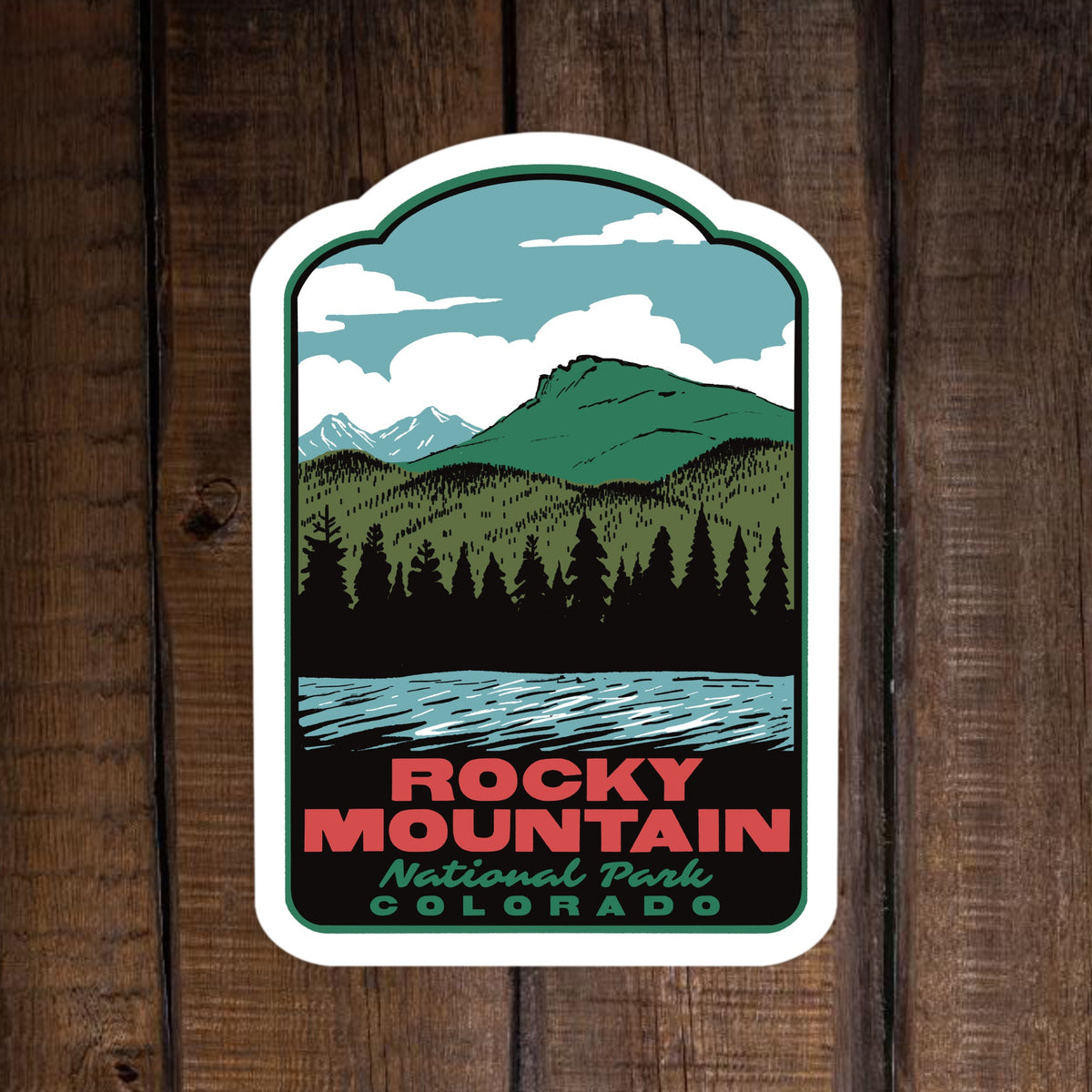 a sticker of Lily Lake in Rocky Mountain National Park on a wood surface