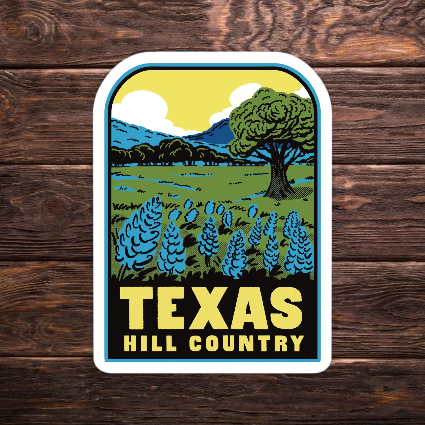 Sticker with 'Texas Hill Country' design on a wooden surface