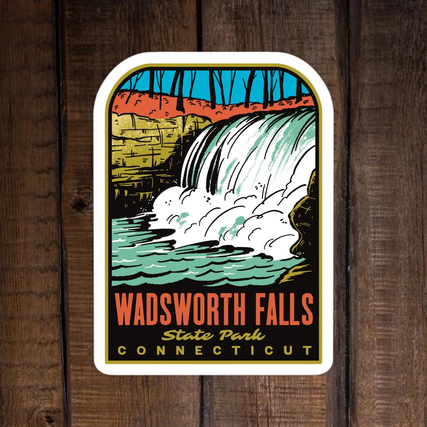 A sticker of Wadsworth Falls State Park Connecticut on a wood surface
