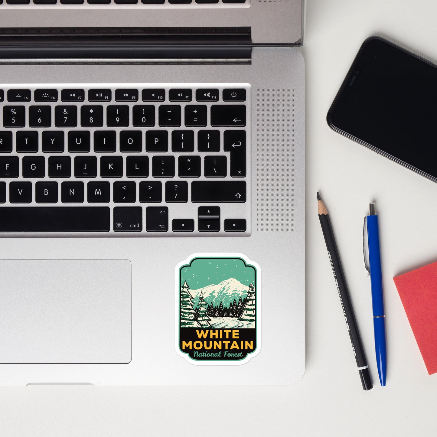 A sticker of White Mountain National Forest on a laptop