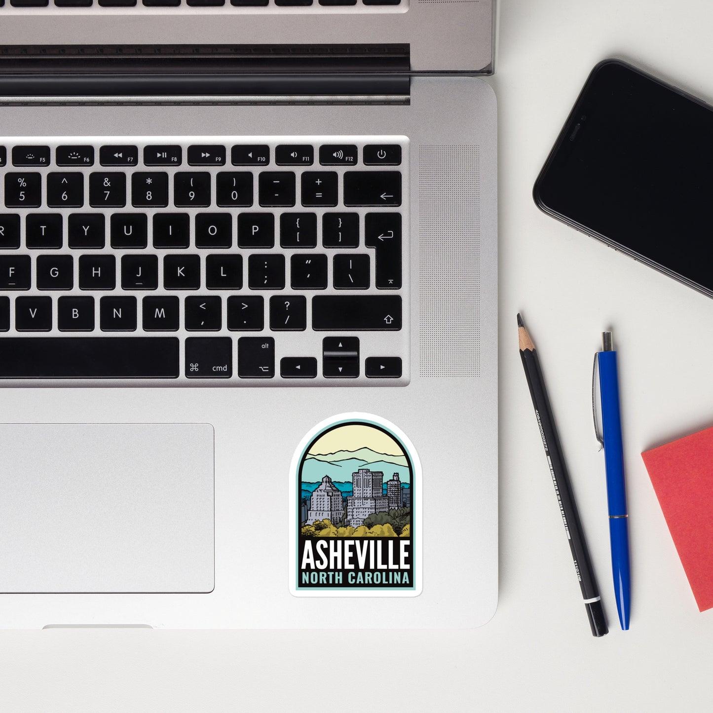 A 3 inch sticker of Asheville North Carolina on a laptop