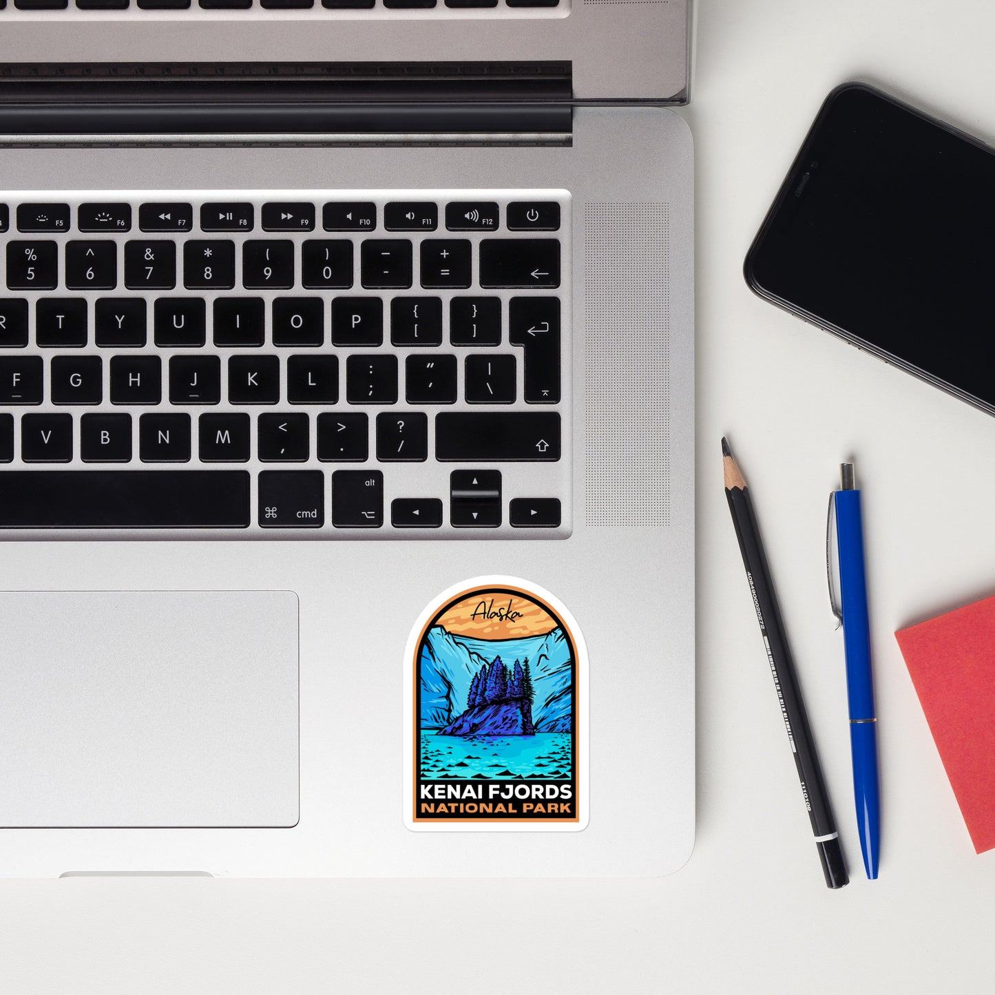 A sticker of Kenai Fjords National Park on a laptop