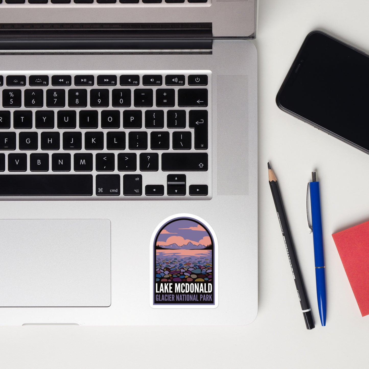 A sticker of Lake McDonald Montana on a laptop
