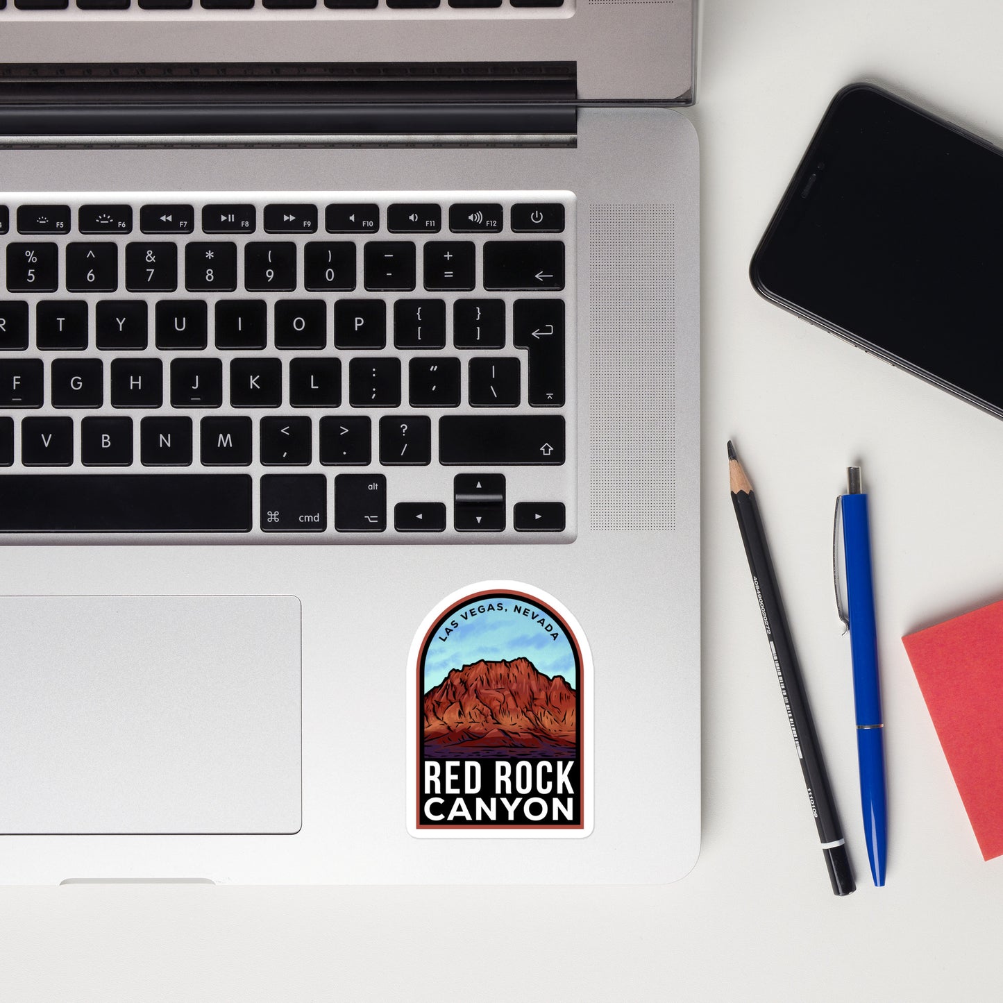 A sticker of Red Rock Canyon on a laptop