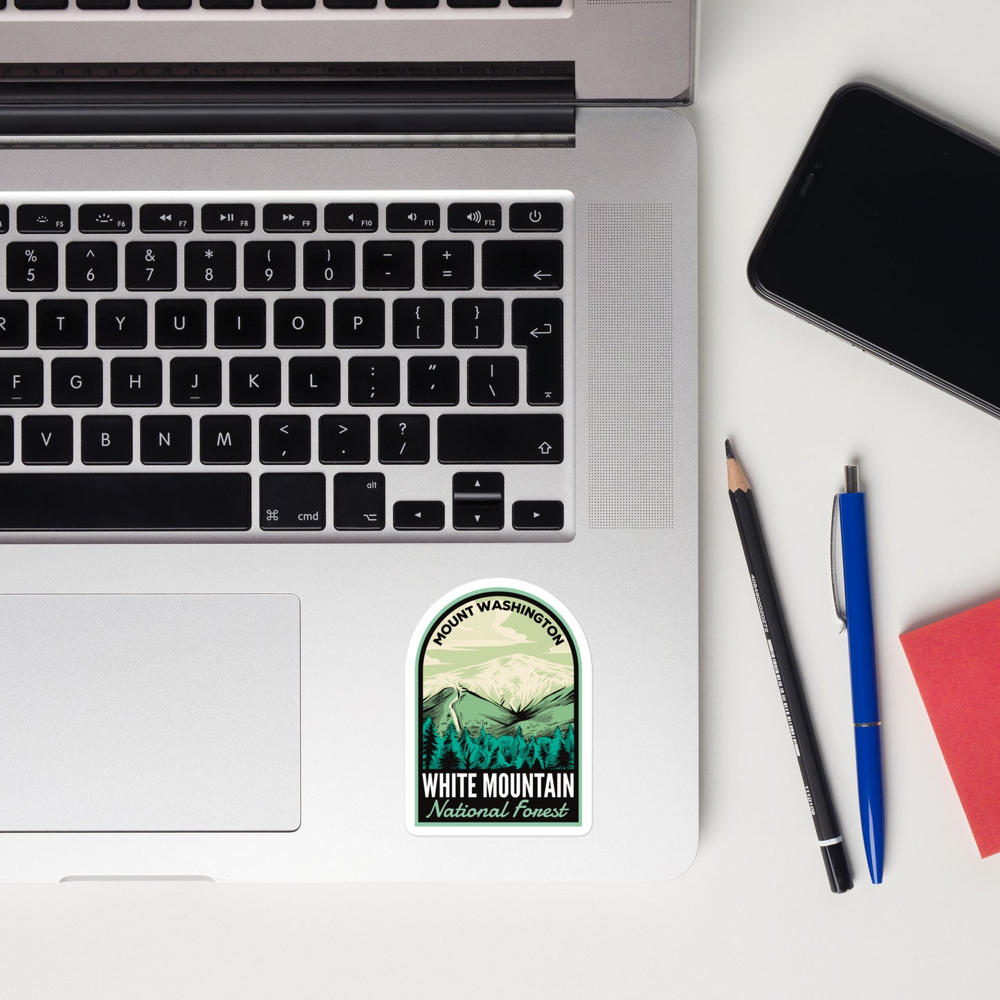 A sticker of White Mountain National Forest on a laptop