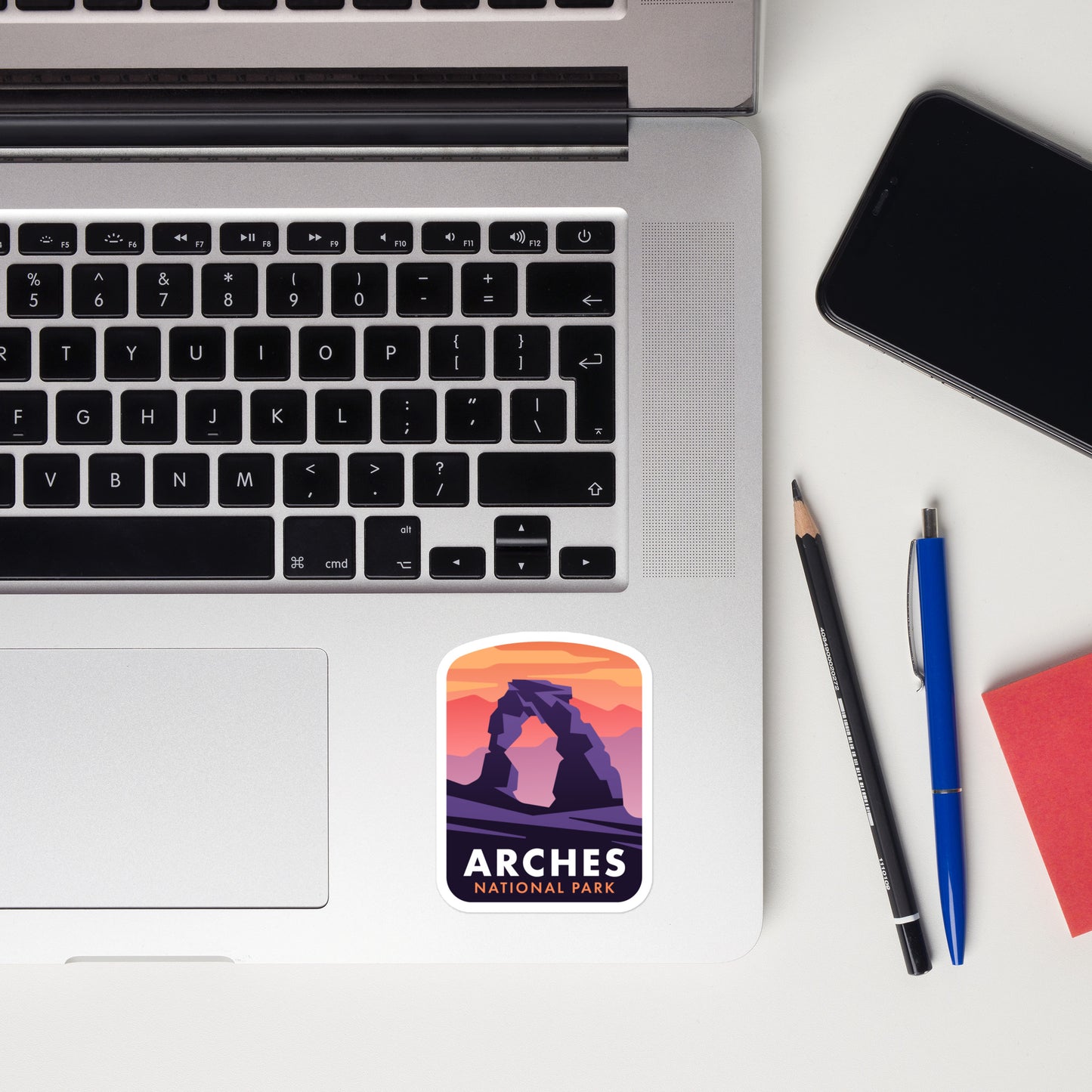 A sticker of Arches National Park on a laptop