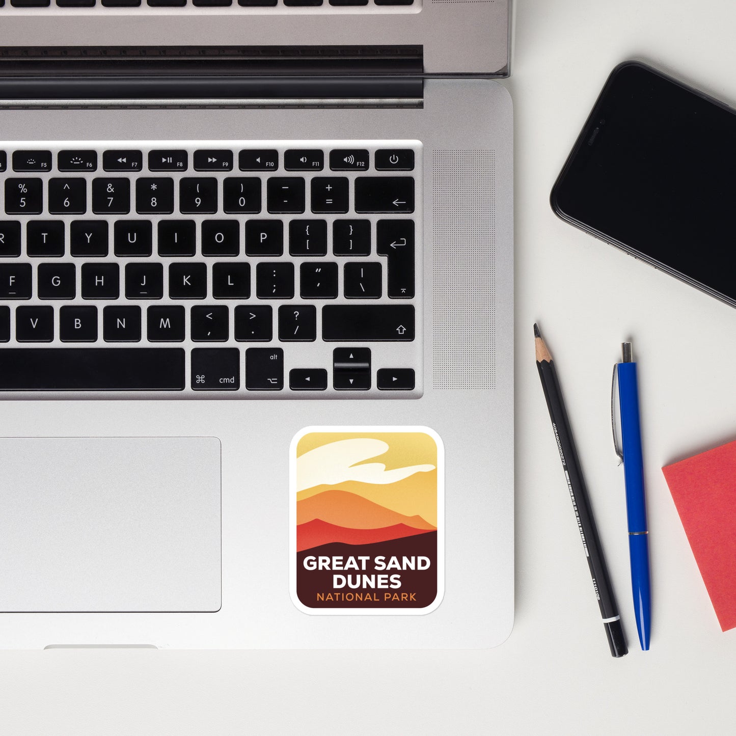 A sticker of Great Sand Dunes National Park on a laptop