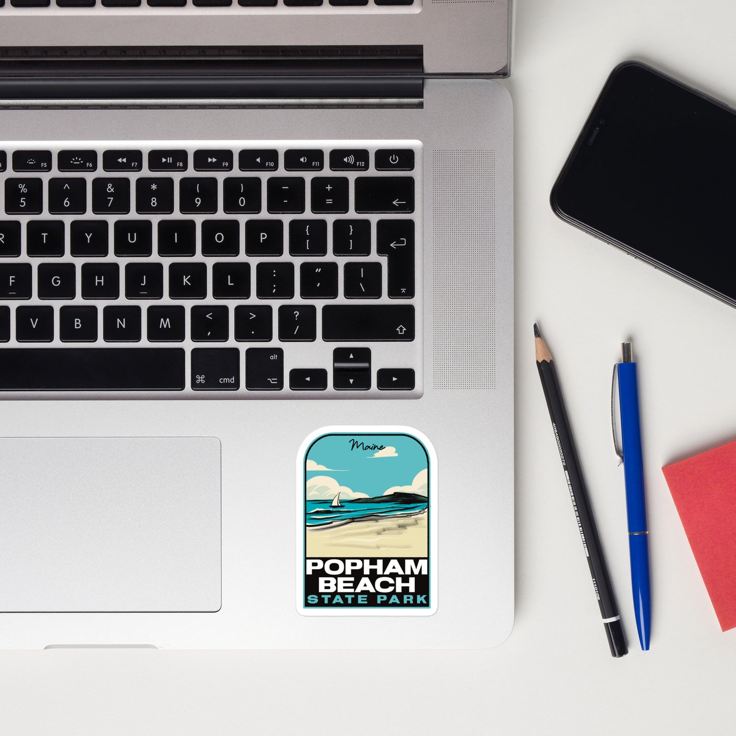 A sticker of Popham Beach State Park on a laptop