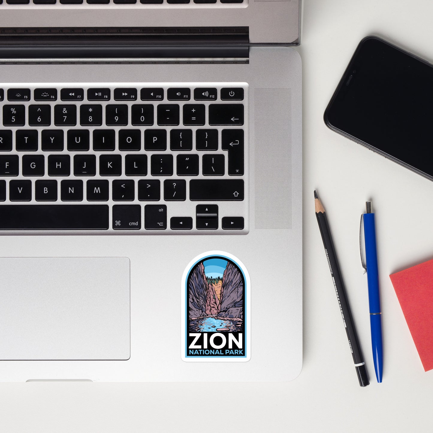 A sticker of Zion National Park on a laptop
