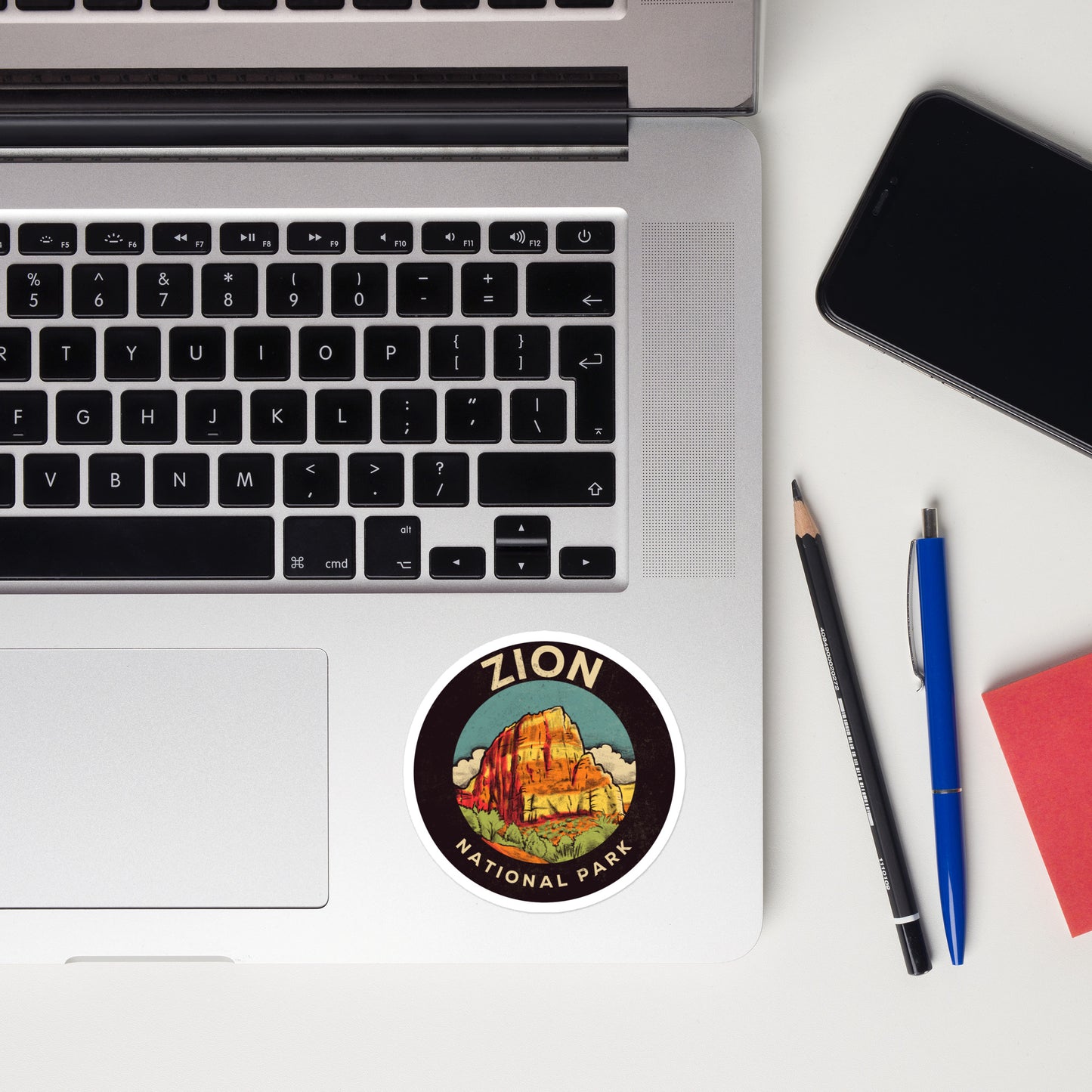 A sticker of Zion National Park on a laptop
