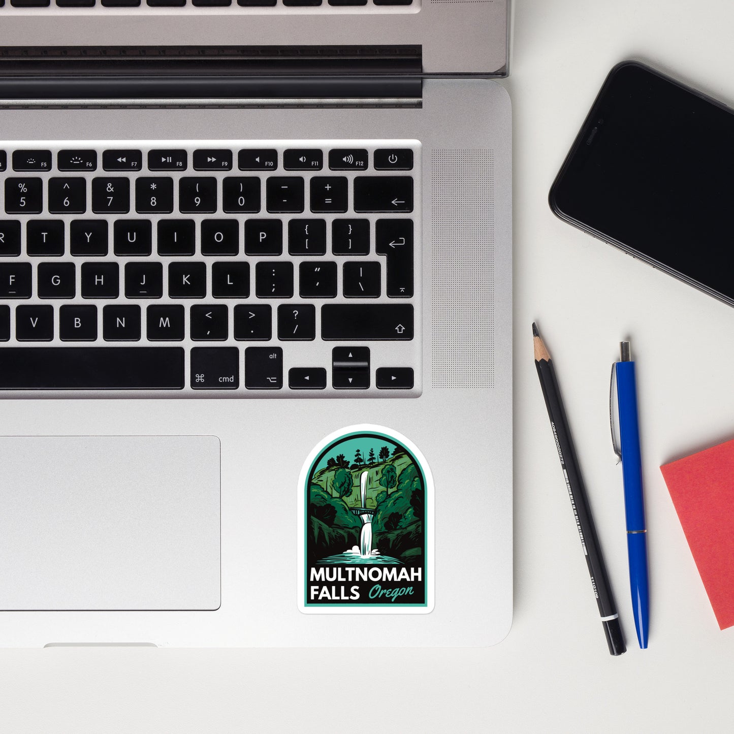 A sticker of Multnomah Falls Oregon on a laptop