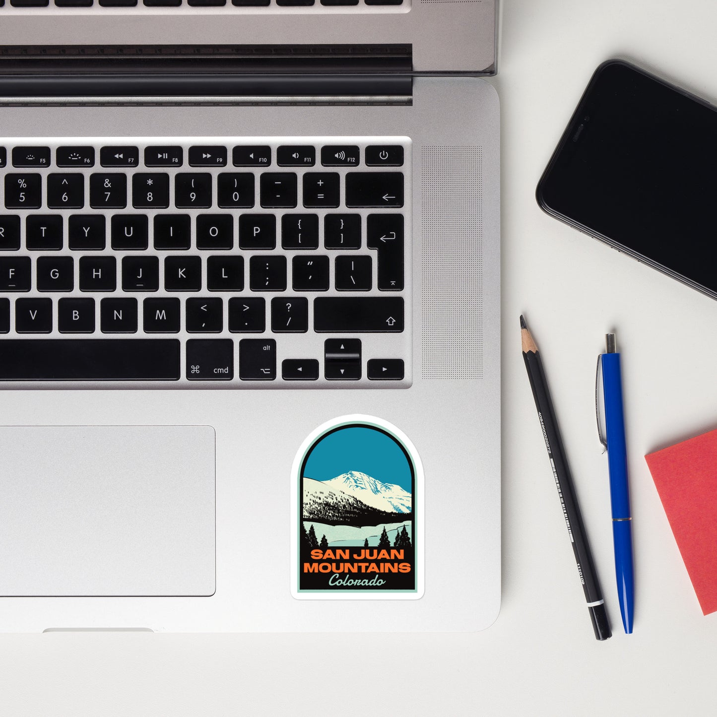 A sticker of the San Juan Mountains on a laptop