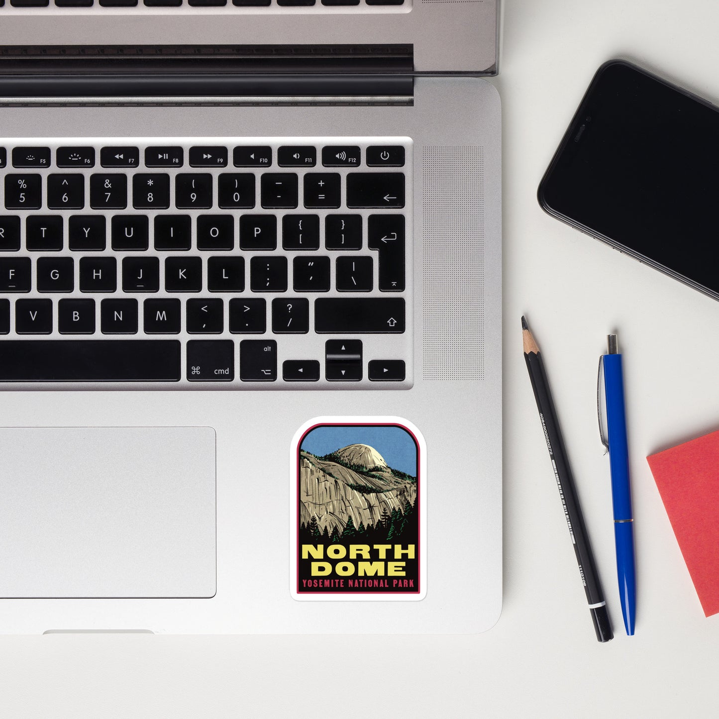 A sticker of North Dome in Yosemite on a laptop
