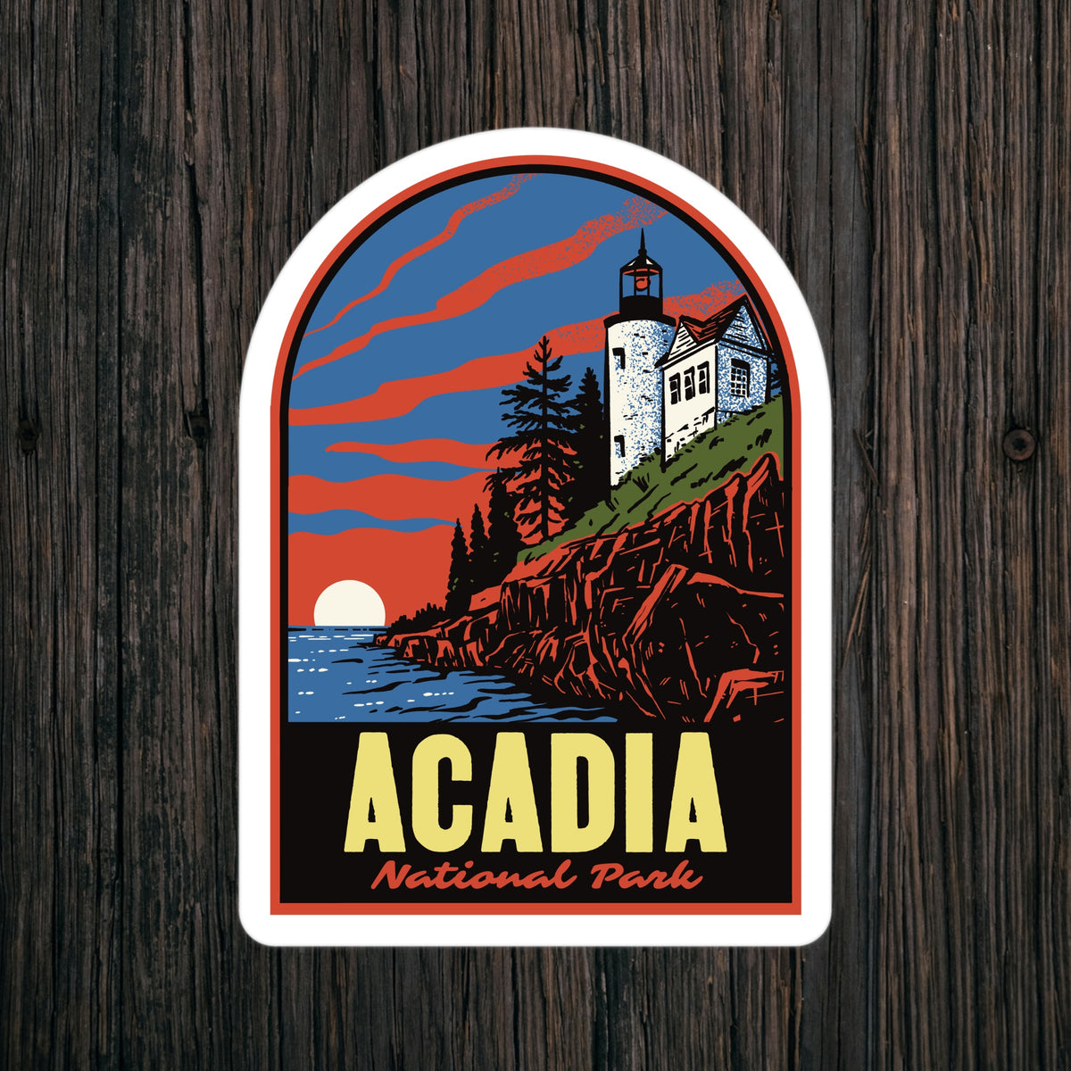 a sticker of Acadia National Park on a wood background