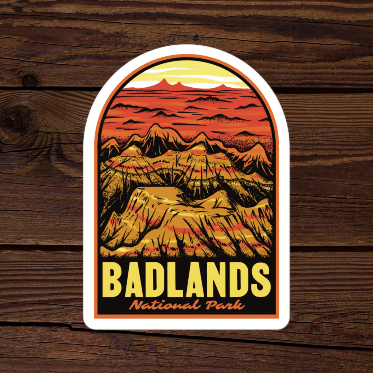a sticker of Badlands National Park on a wood background