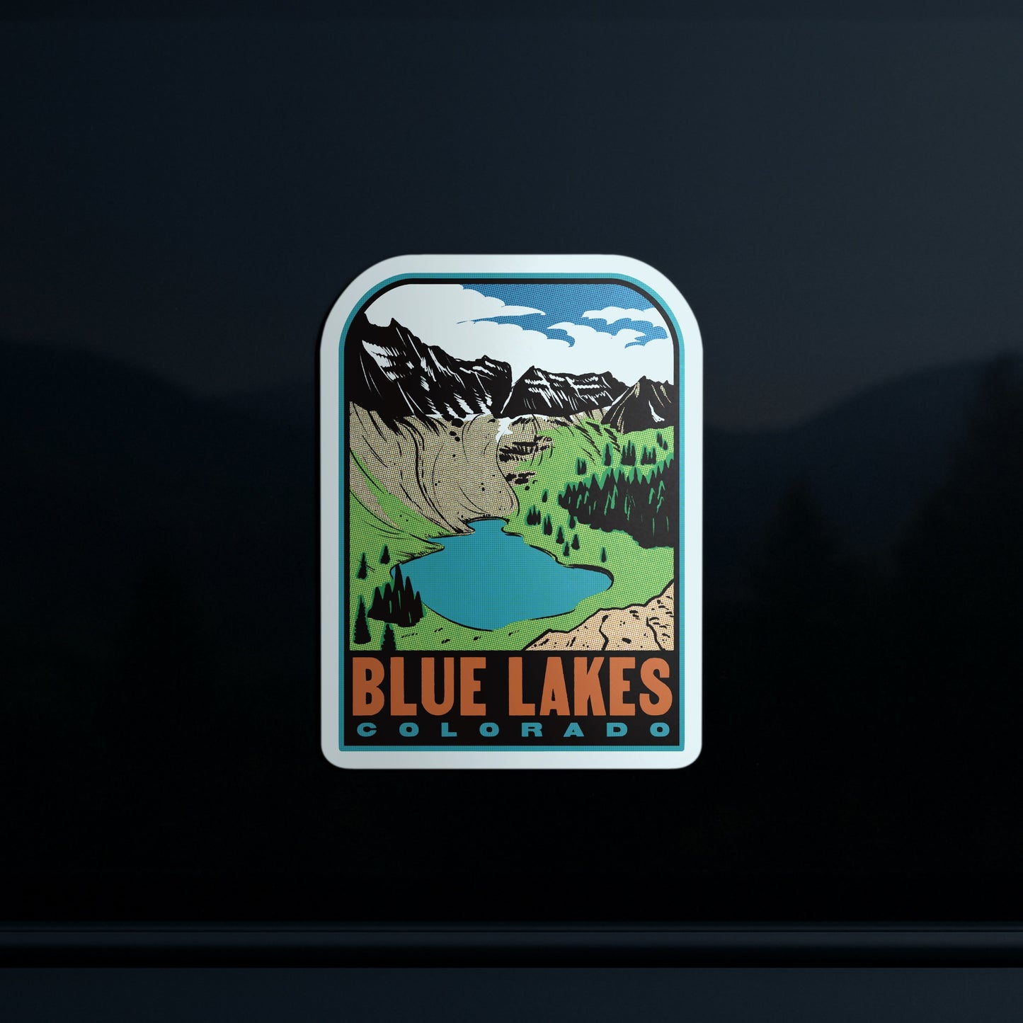 Sticker with a scenic design of mountains and a lake, labeled 'Blue Lakes Colorado', on a dark background.
