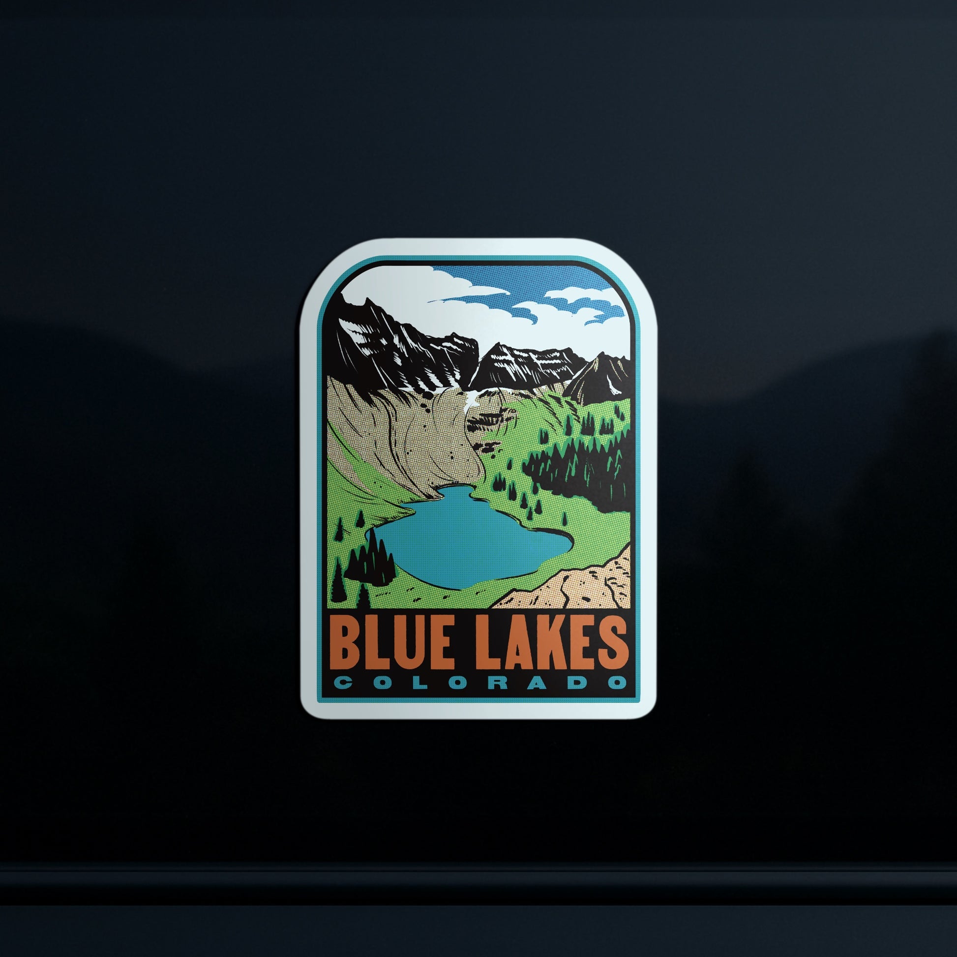 Sticker with a scenic design of mountains and a lake, labeled 'Blue Lakes Colorado', on a dark background.