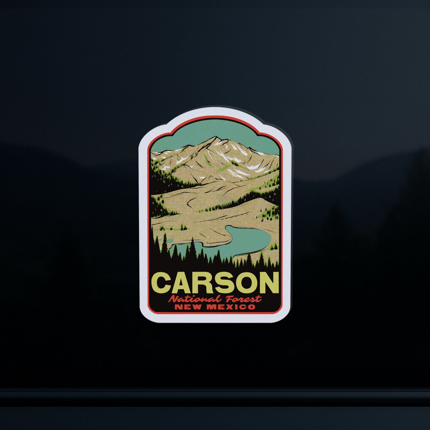 Sticker of Carson National Forest, New Mexico with mountain and lake illustration on a dark background