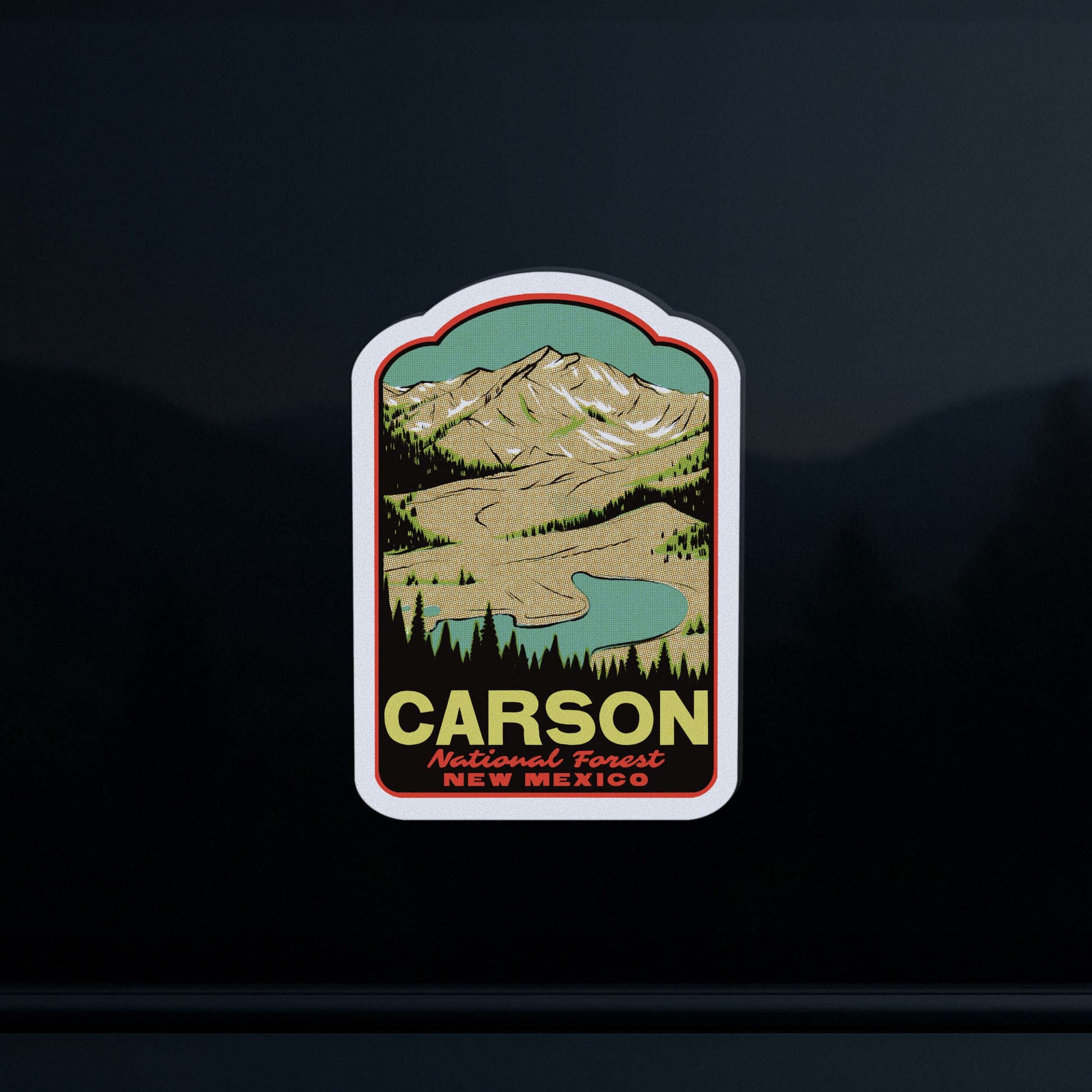 Sticker of Carson National Forest, New Mexico with mountain and lake illustration on a dark background
