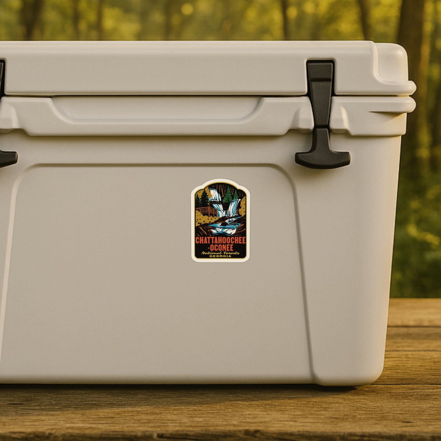 Beige cooler with a sticker on a wooden surface with a blurred natural background