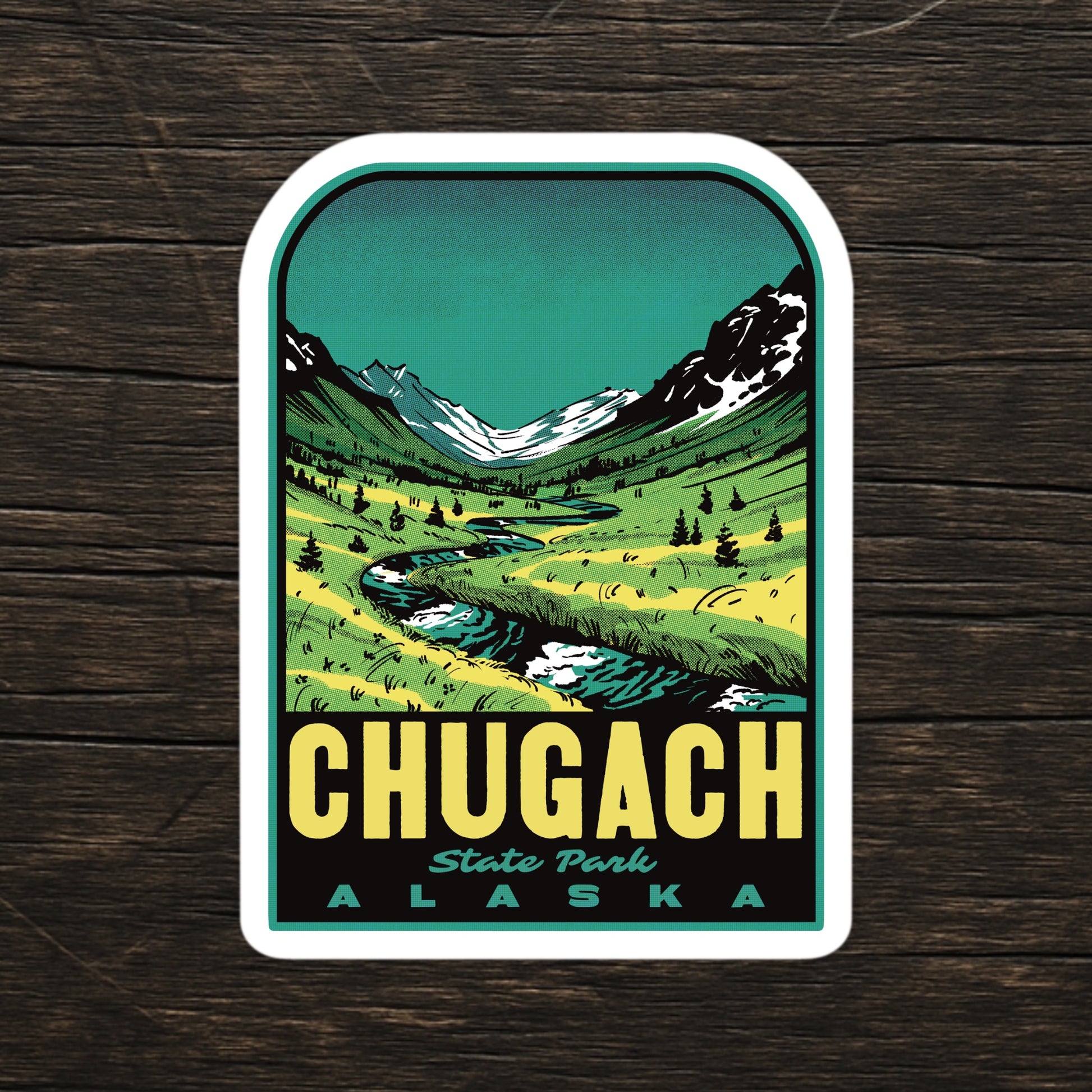 Retro Chugach Alaska sticker on wood surface, showcasing bold vintage design with trees, mountains, and rivers—durable, waterproof vinyl ideal for hikers and outdoor enthusiasts
