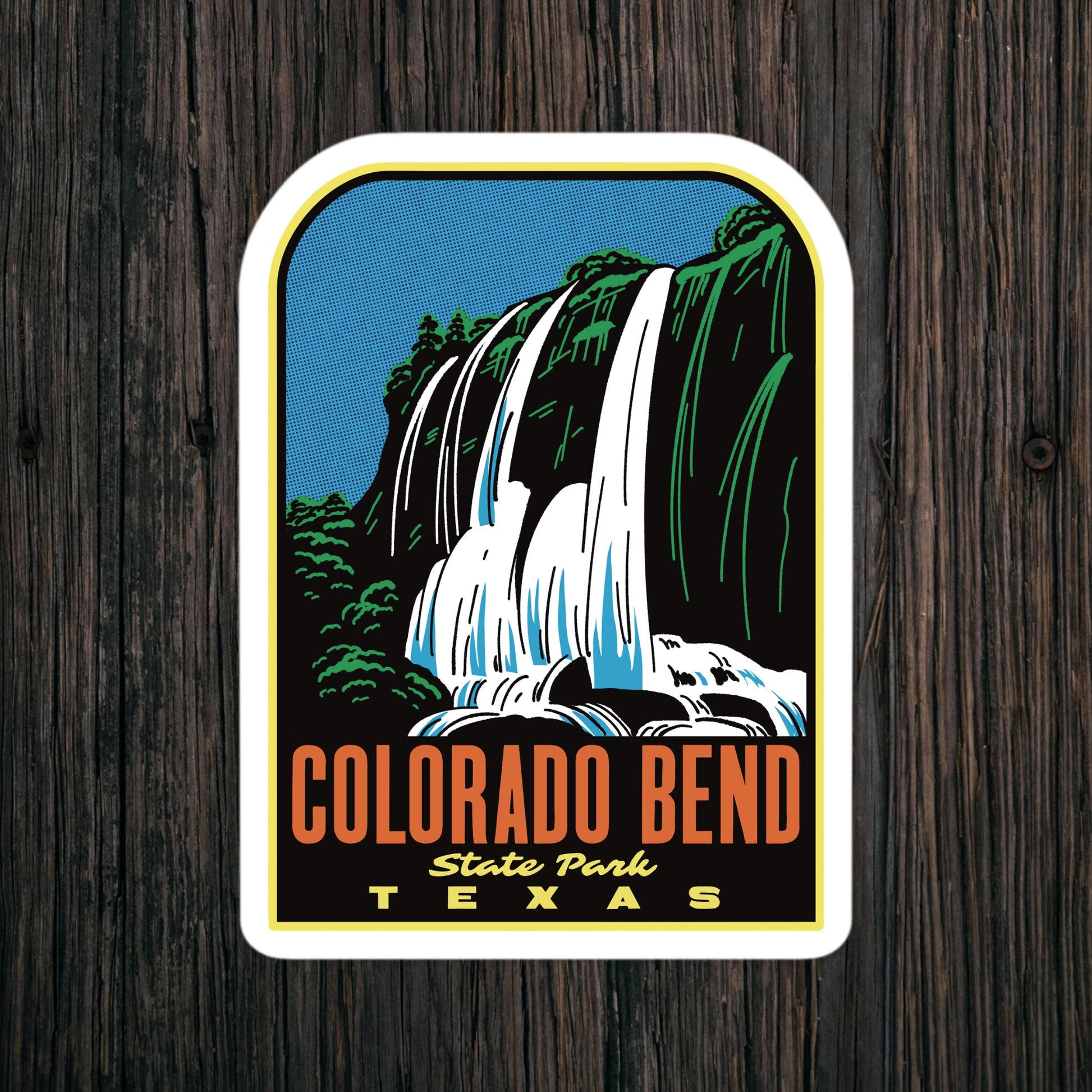 Sticker of Colorado Bend State Park, Texas with a waterfall design on a wooden background