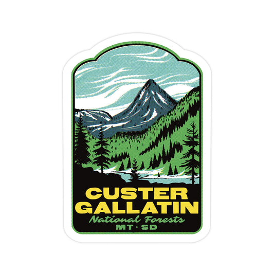 A die-cut sticker featuring a retro-style illustration of Custer Gallatin National Forests in Montana, with a mountain, pine trees, and a lake, and the text 'CUSTER GALLATIN National Forests MT. SD' in yellow and green.