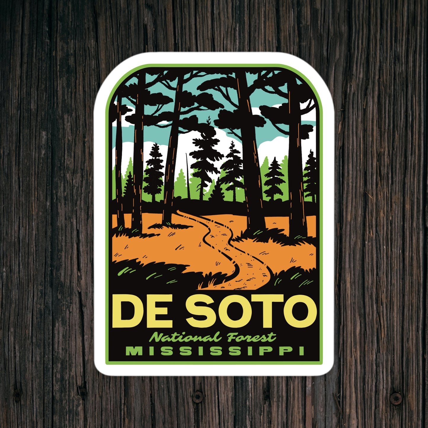 Sticker of De Soto National Forest, Mississippi with a forest design on a wooden background.