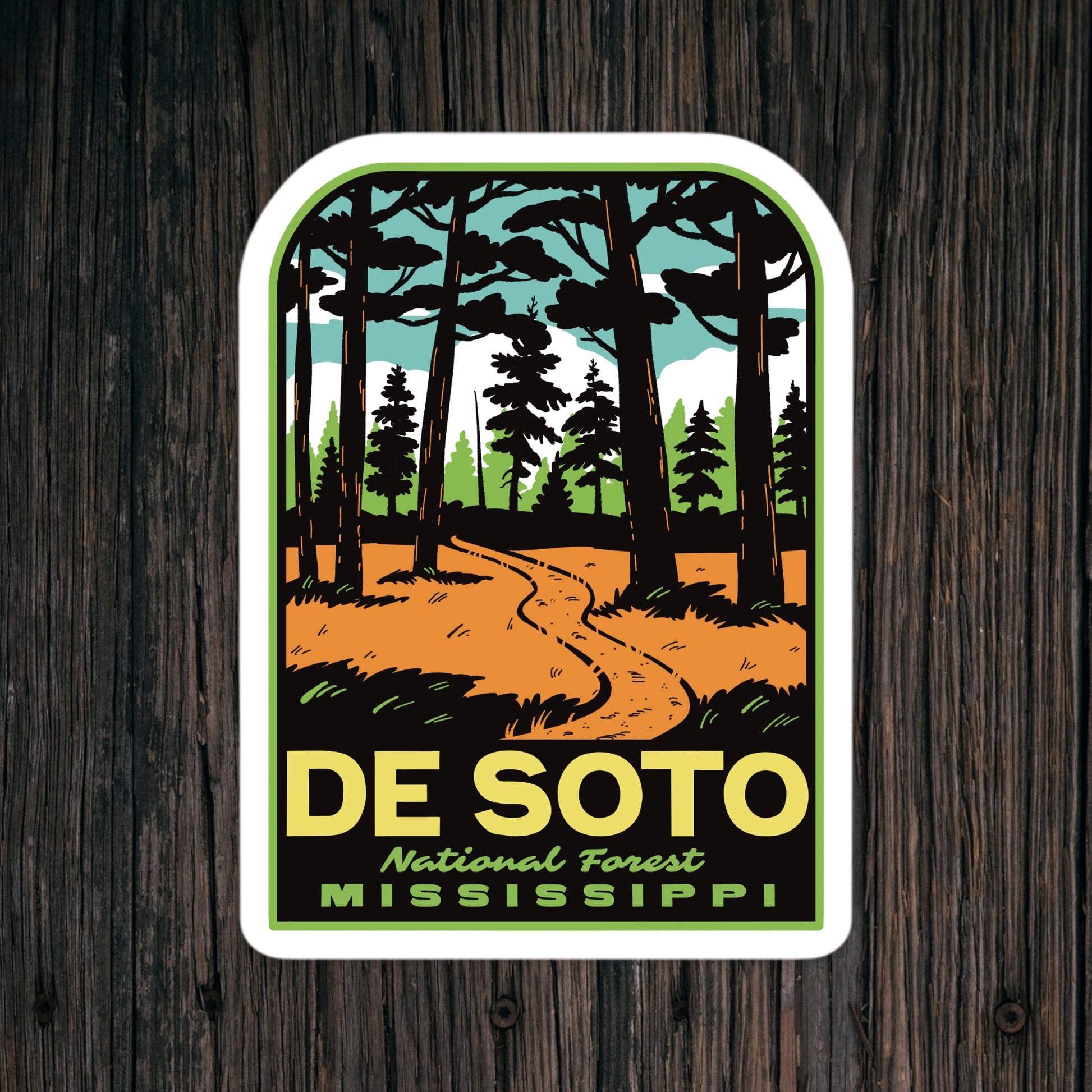 Sticker of De Soto National Forest, Mississippi with a forest design on a wooden background.