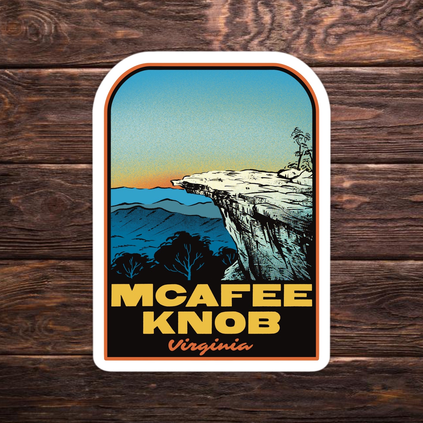 Sticker of McAfee Knob, Virginia with a scenic illustration on a wooden background