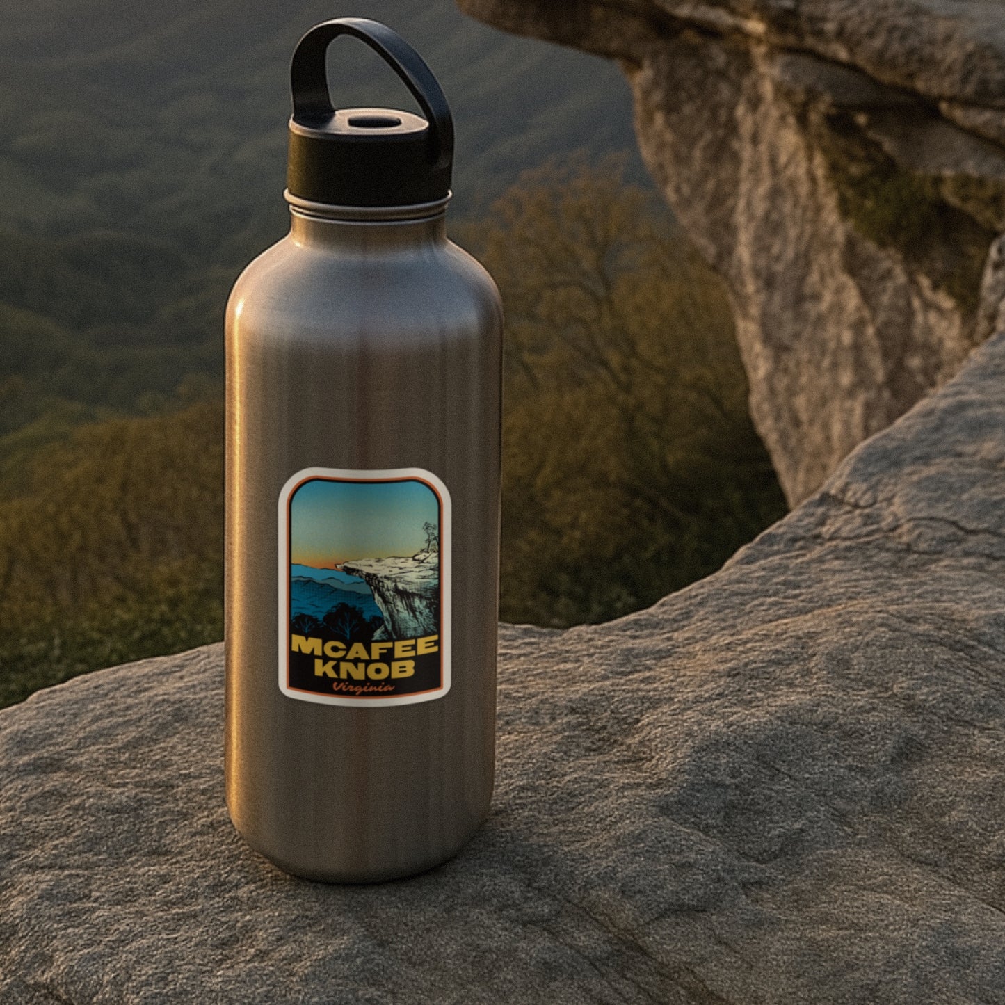 Metal water bottle with a label on a rock with a scenic background