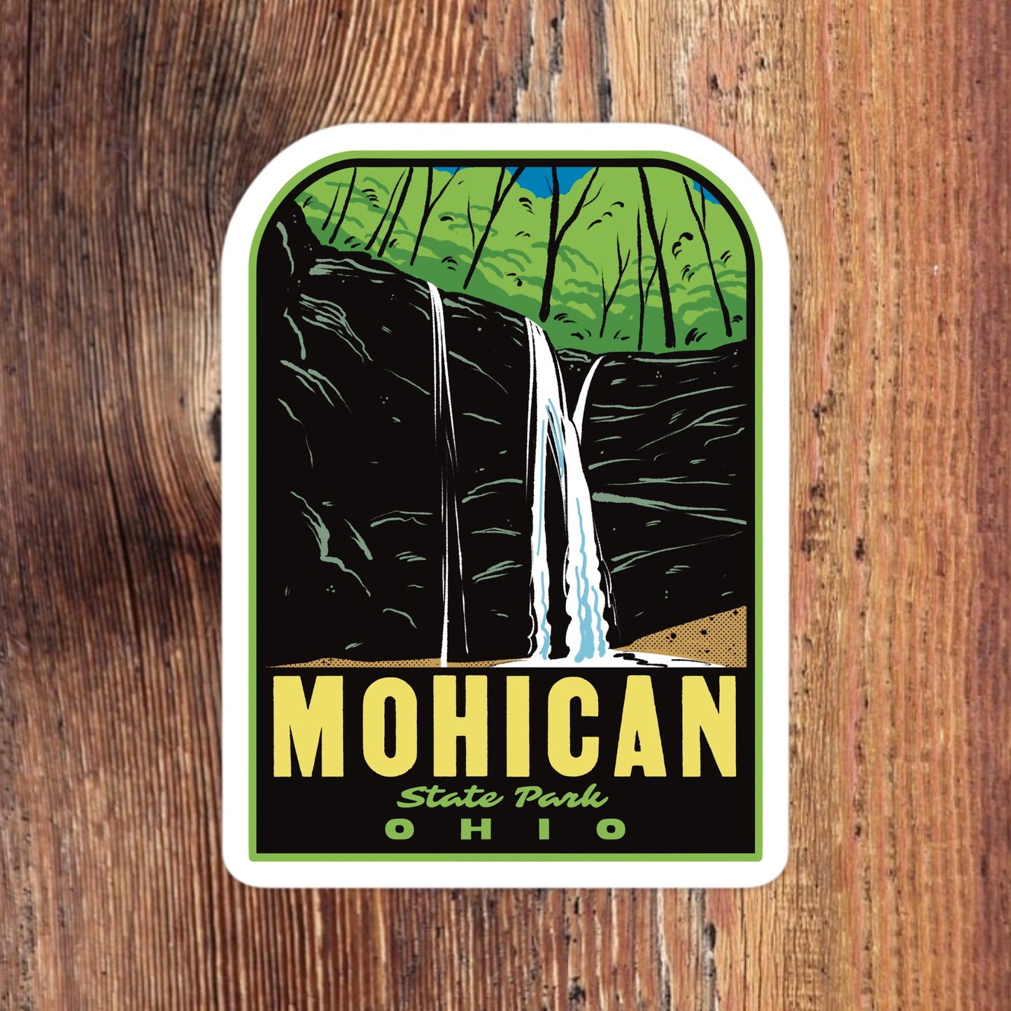 Sticker of Mohican State Park, Ohio with a waterfall design on a wooden background