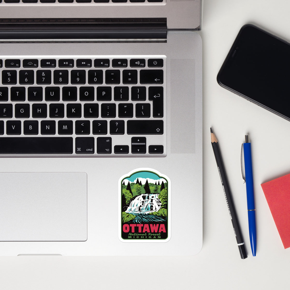 A kiss cut sticker that reads "Ottawa National Forest Michigan" on a laptop palm rest