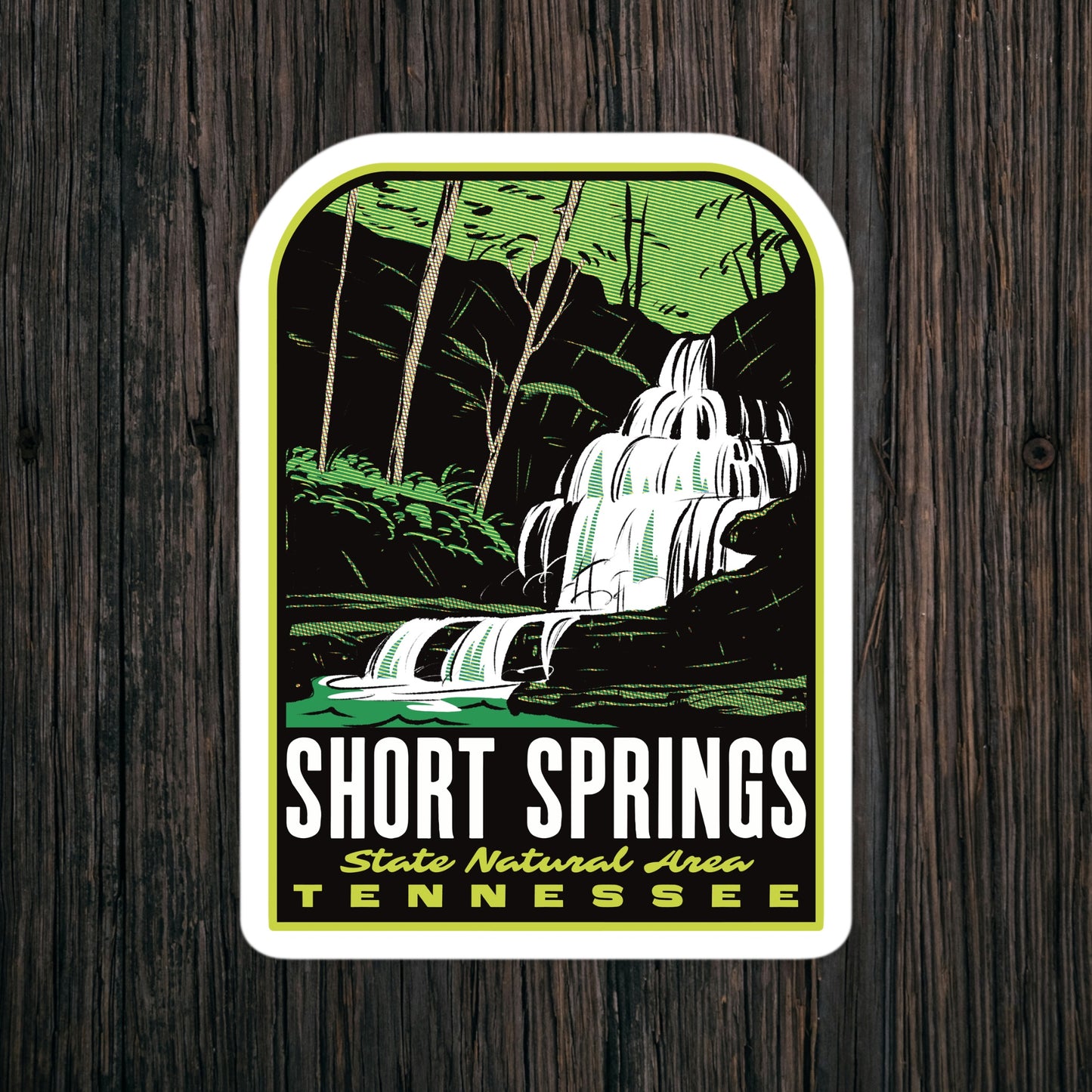 Sticker with a waterfall design and 'Short Springs State Natural Area Tennessee' text on a wooden background