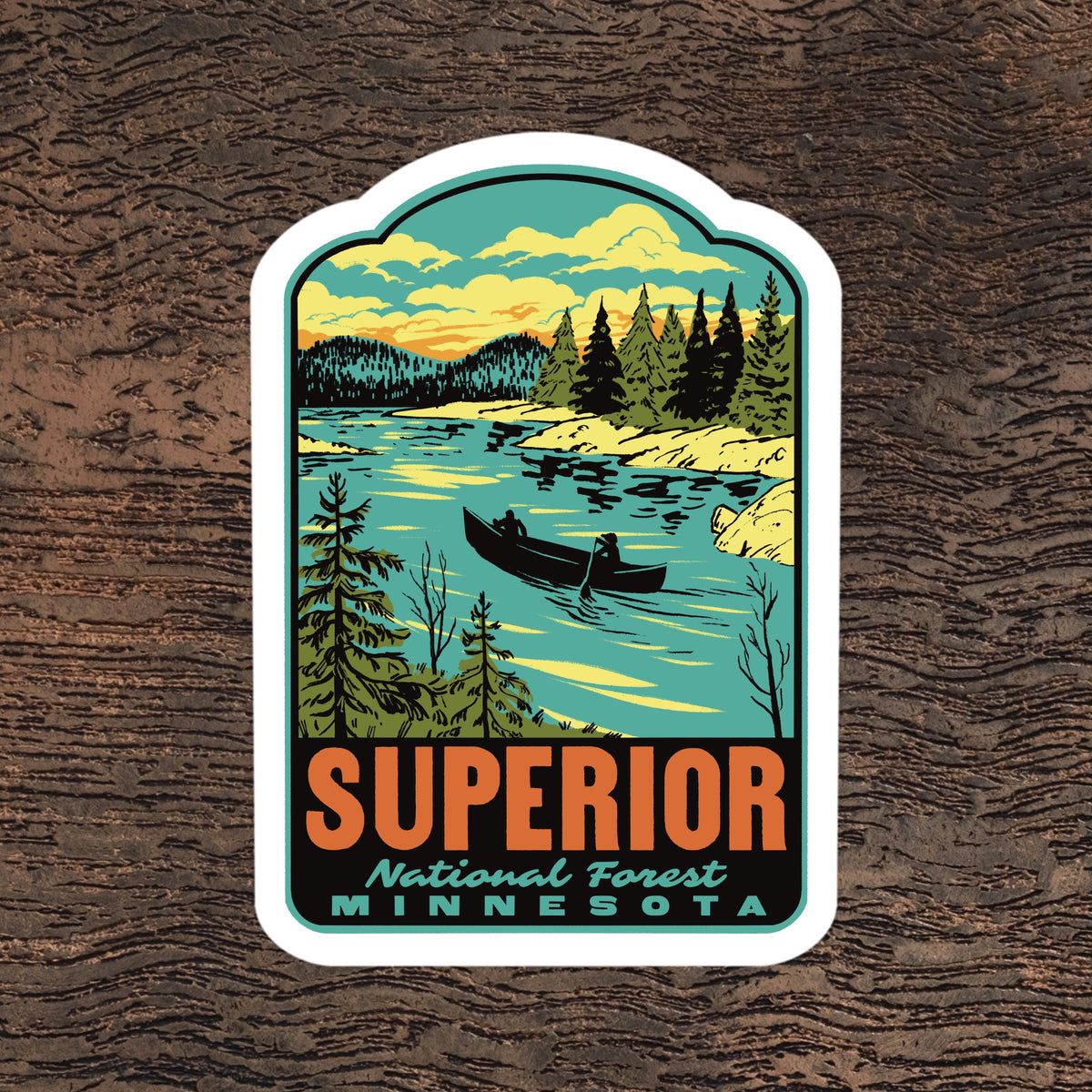 a sticker of superior national forest on a wooden background