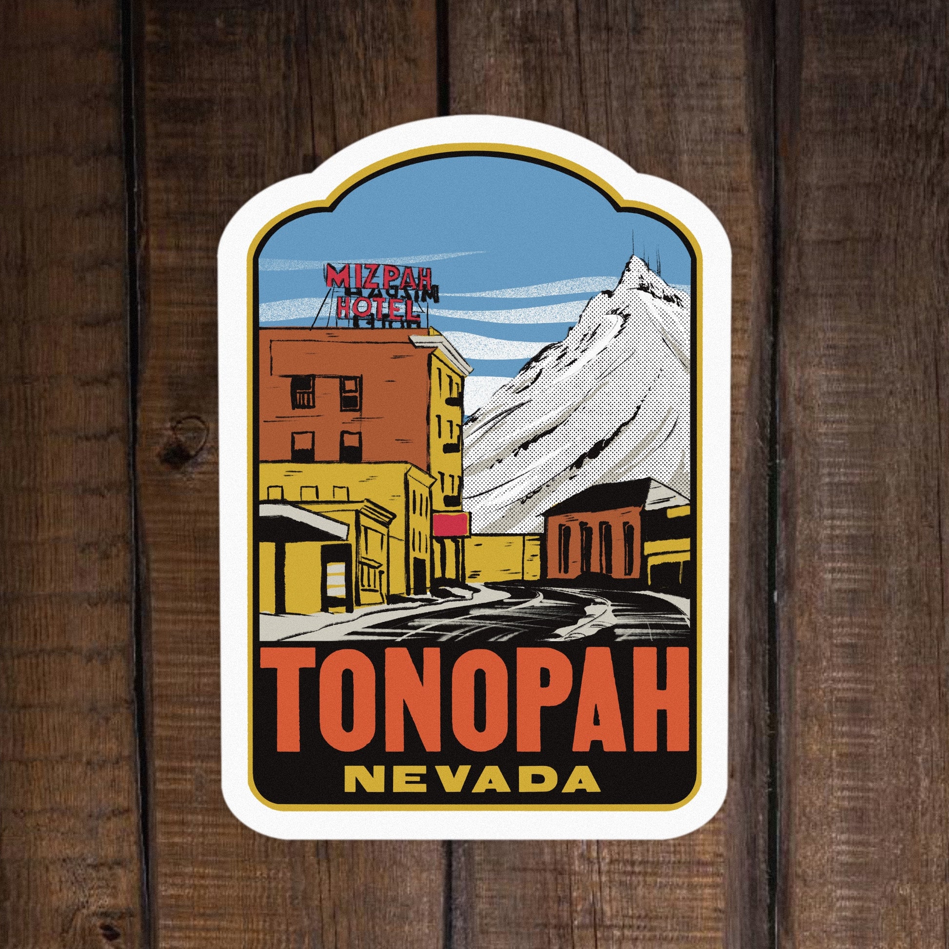 Sticker of Tonopah, Nevada with a mountain and buildings on a wooden background