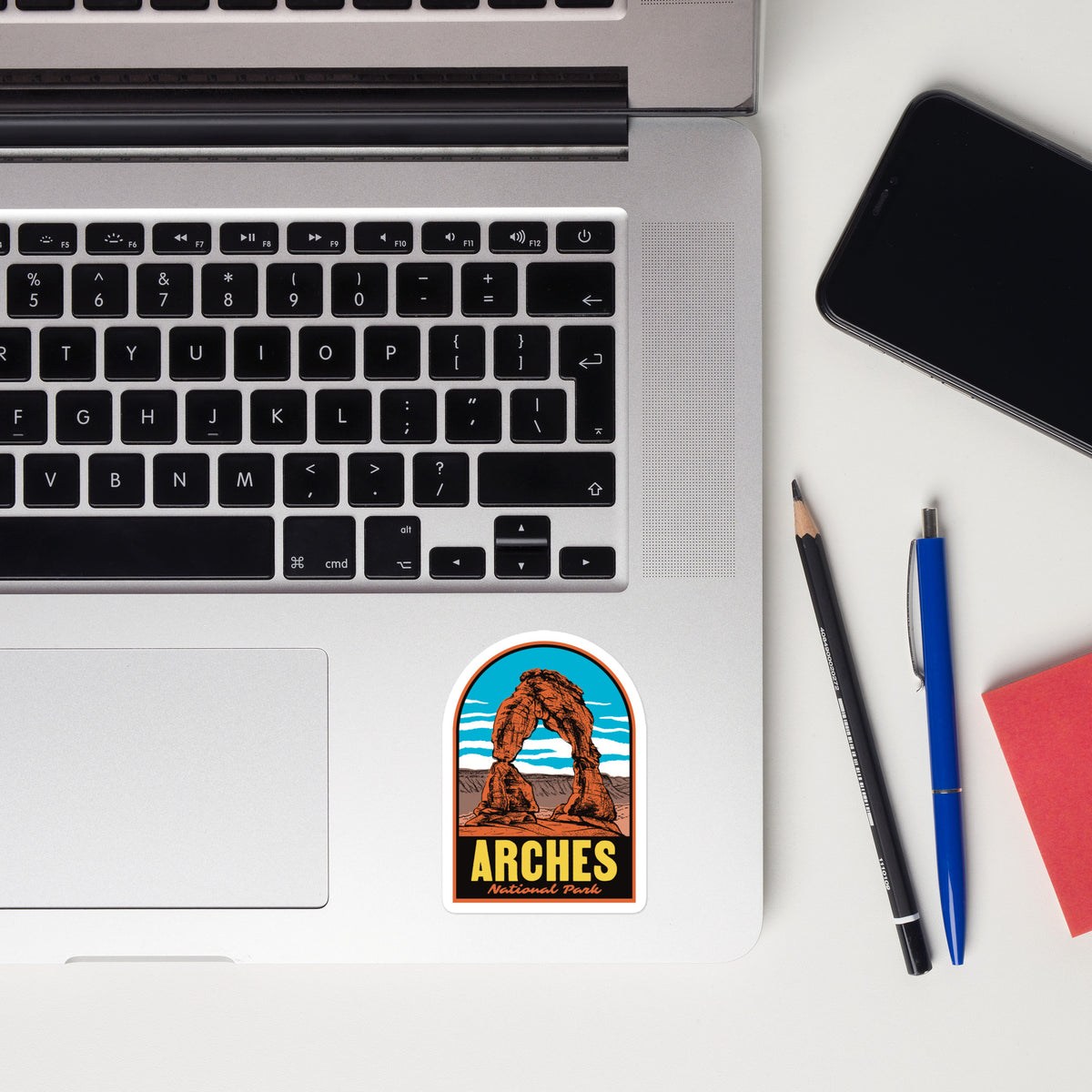 A sticker of Arches National Park on a laptop