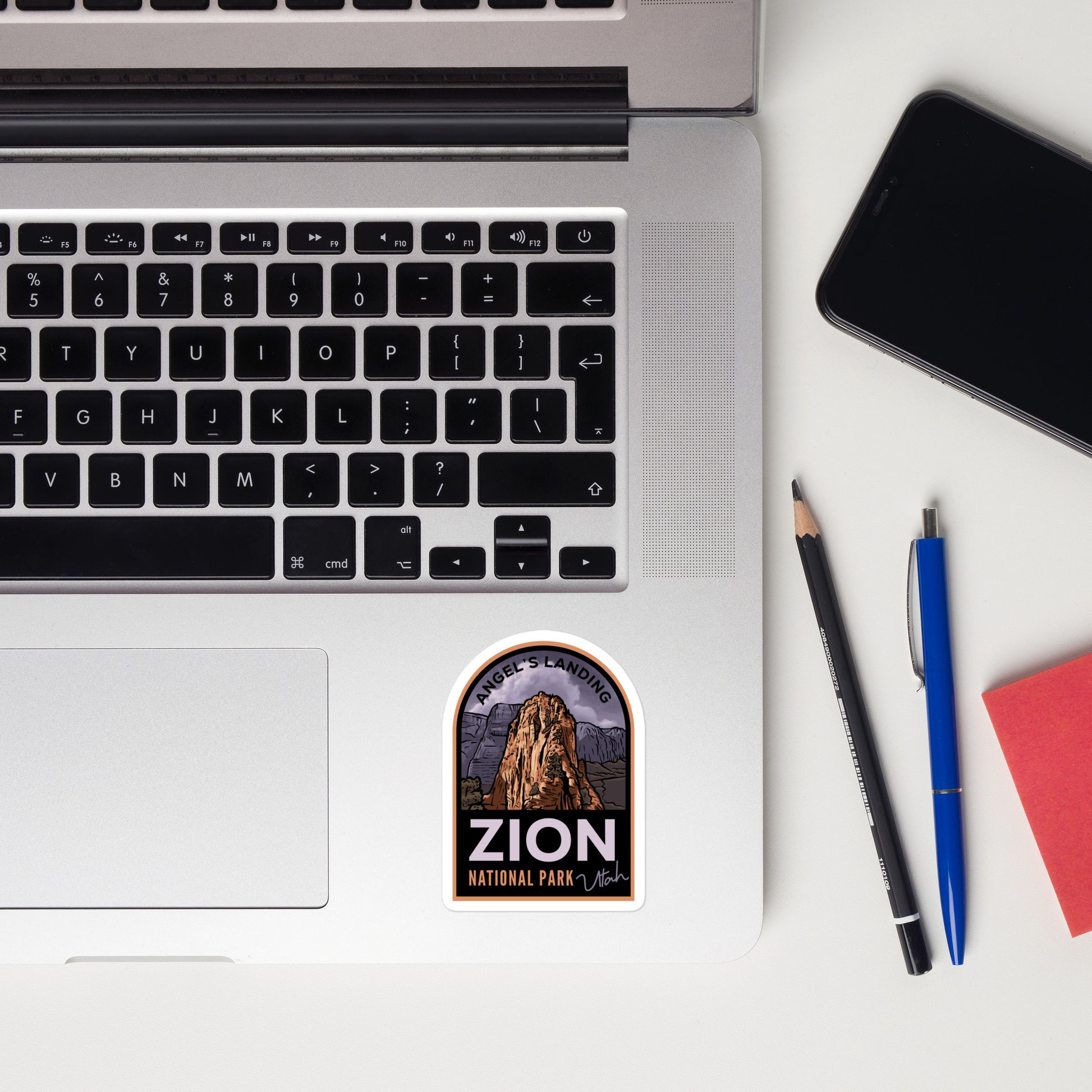 A 3 inch tall sticker of Zion National Park on a laptop