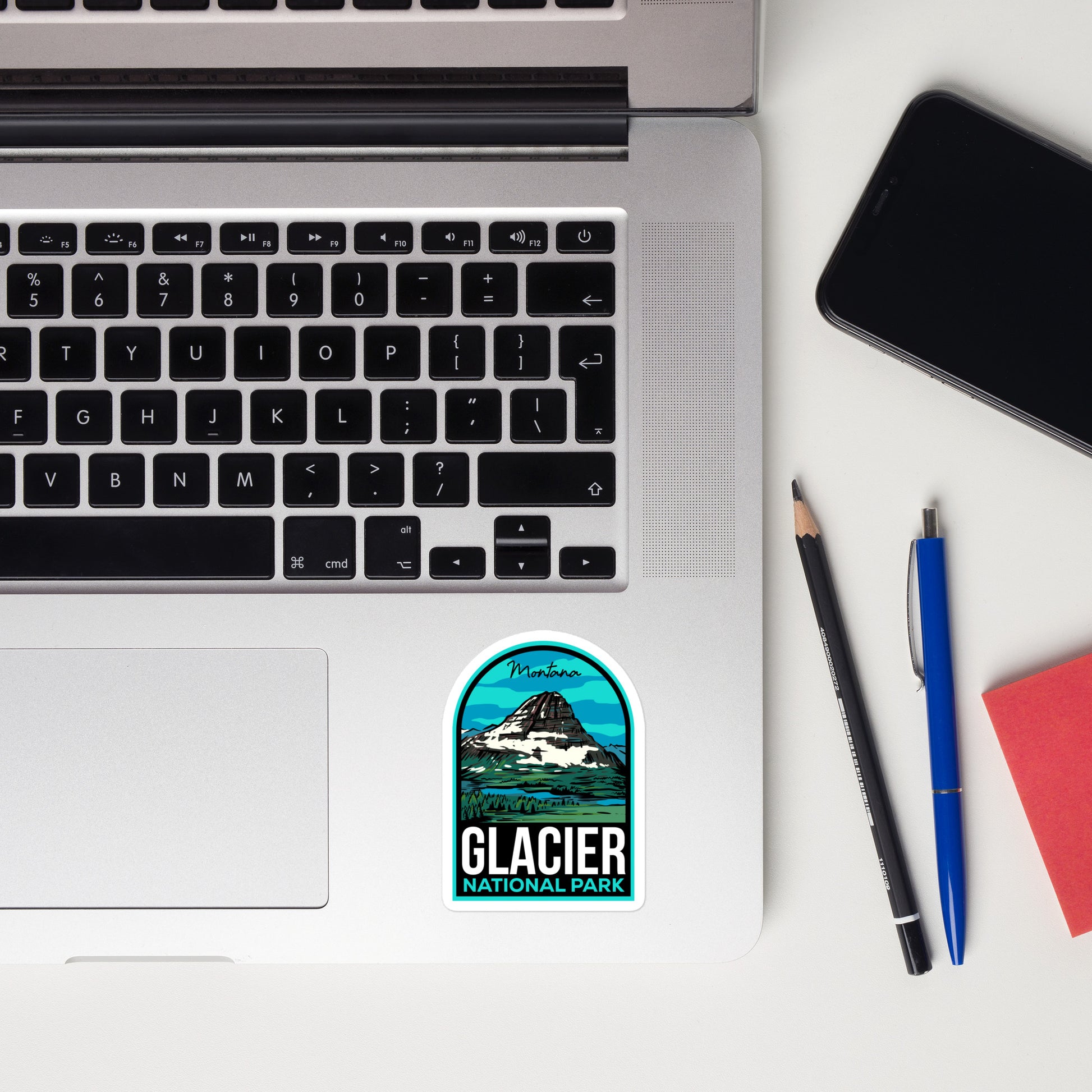 A sticker of Glacier National Park on a laptop