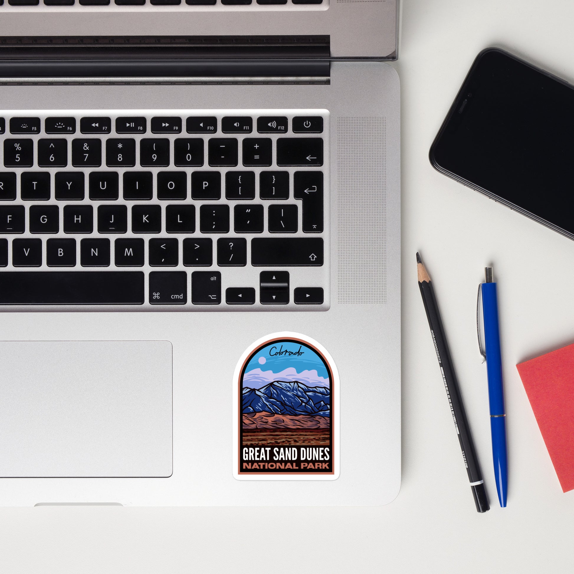 A sticker of Great Sand Dunes National Park on a laptop