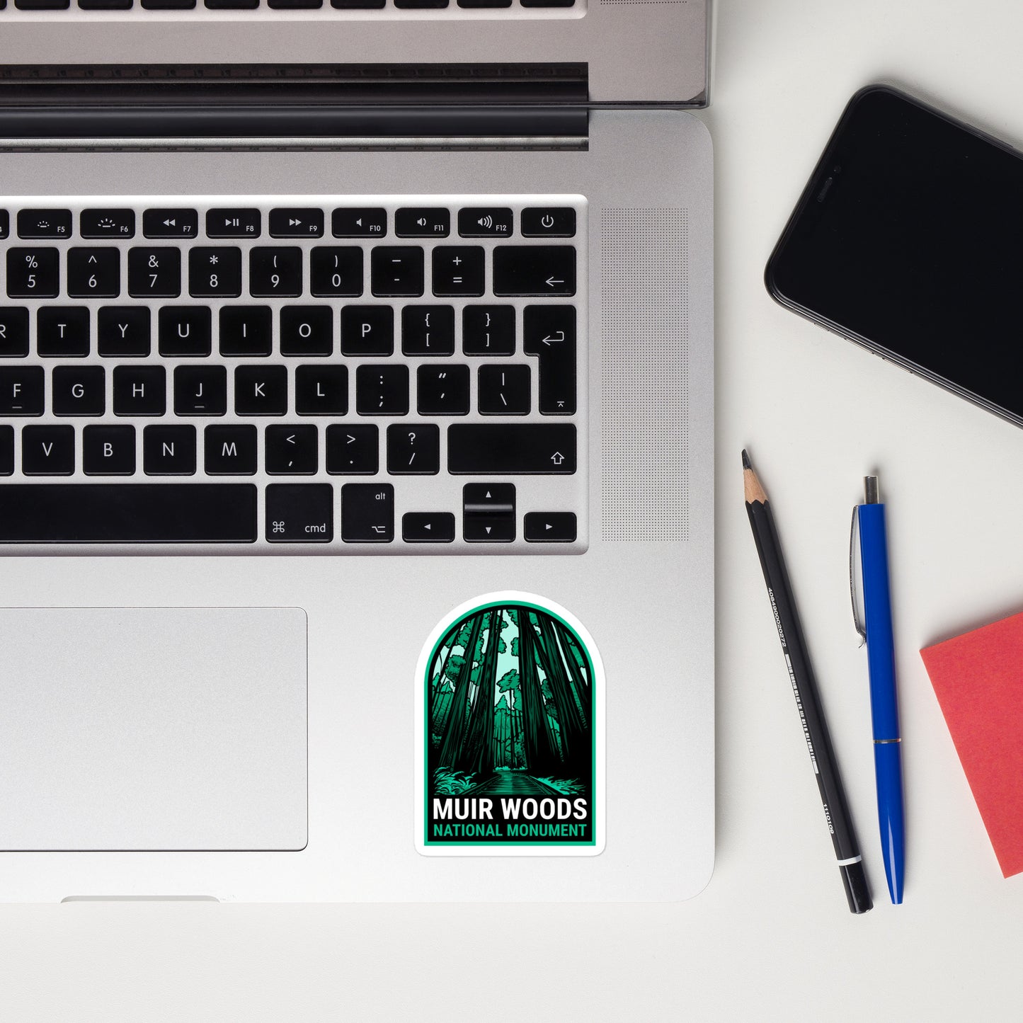 A sticker of Muir Woods National Monument on a laptop