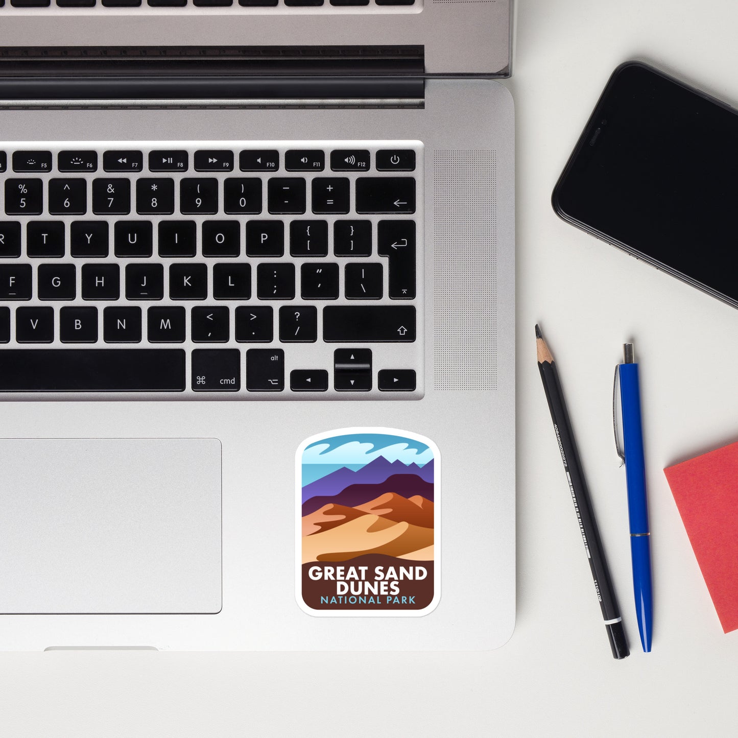 A sticker of Great Sand Dunes National Park on a laptop