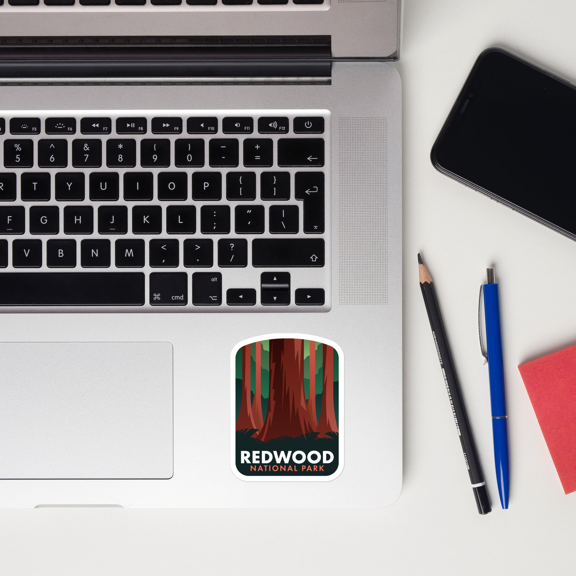 A sticker of Redwood National Park on a laptop