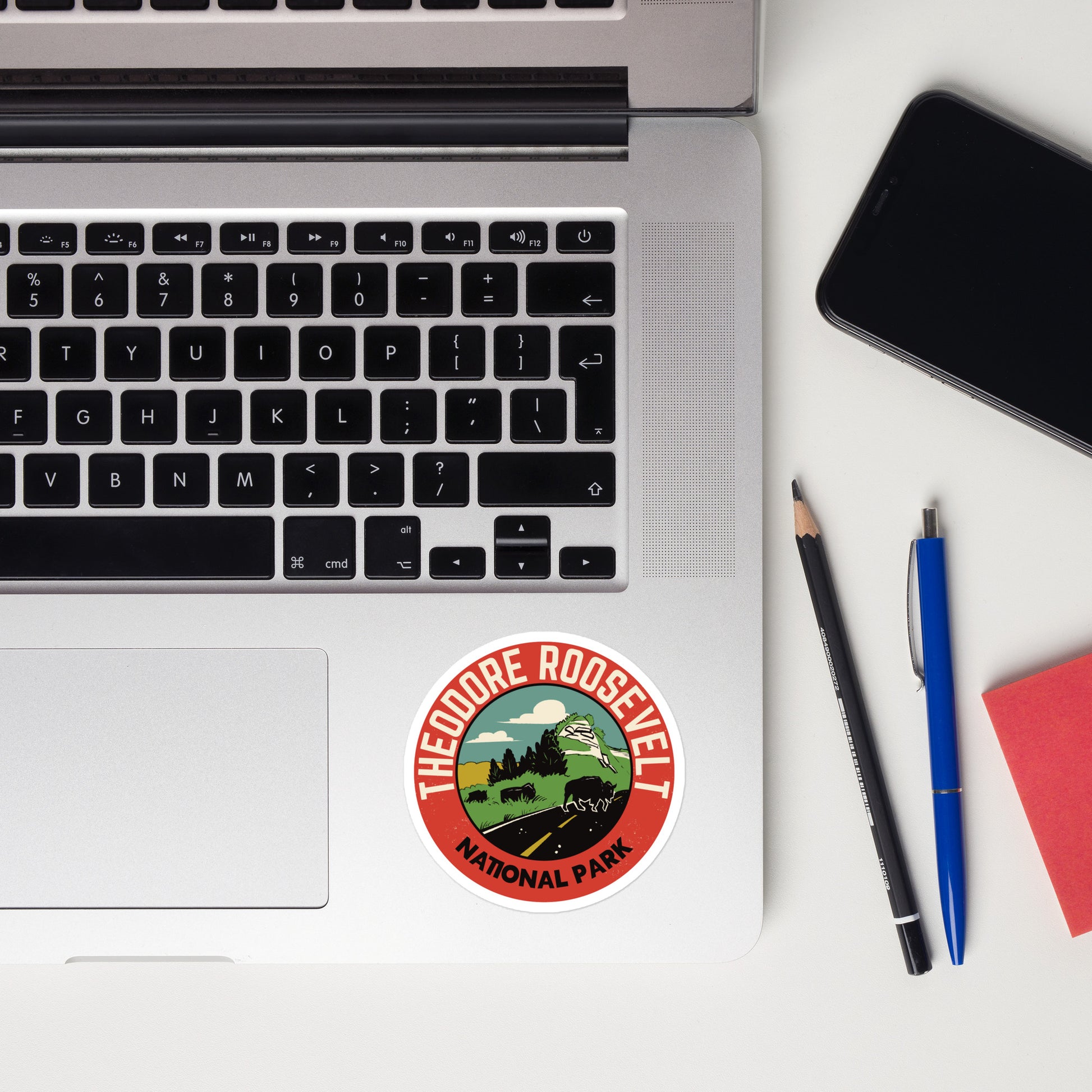 A sticker of Theodore Roosevelt National Park on a laptop